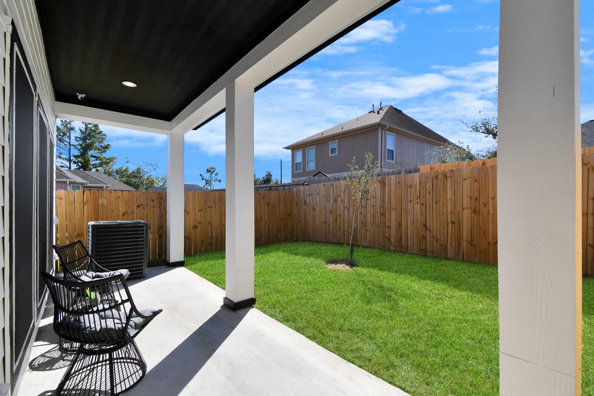 7812 Jester Street, Houston, TX 77051 The covered patio extends the home's living space outdoors, offering a comfortable spot to lounge or dine beside the neatly maintained stretch of verdant lawn.