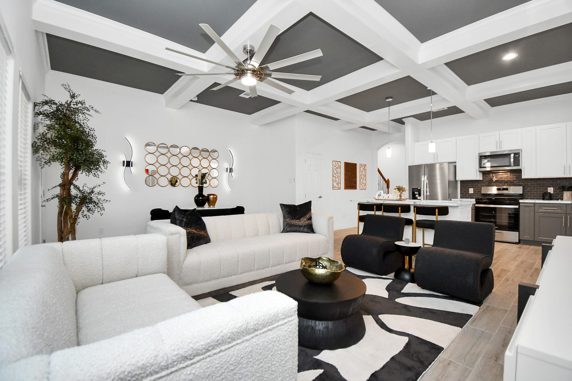 7812 Jester Street, Houston, TX 77051 Grid coffered ceilings add immediate dimension overhead, uniting the open-plan living, dining, and culinary areas beneath cohesive soft-gray finishes.