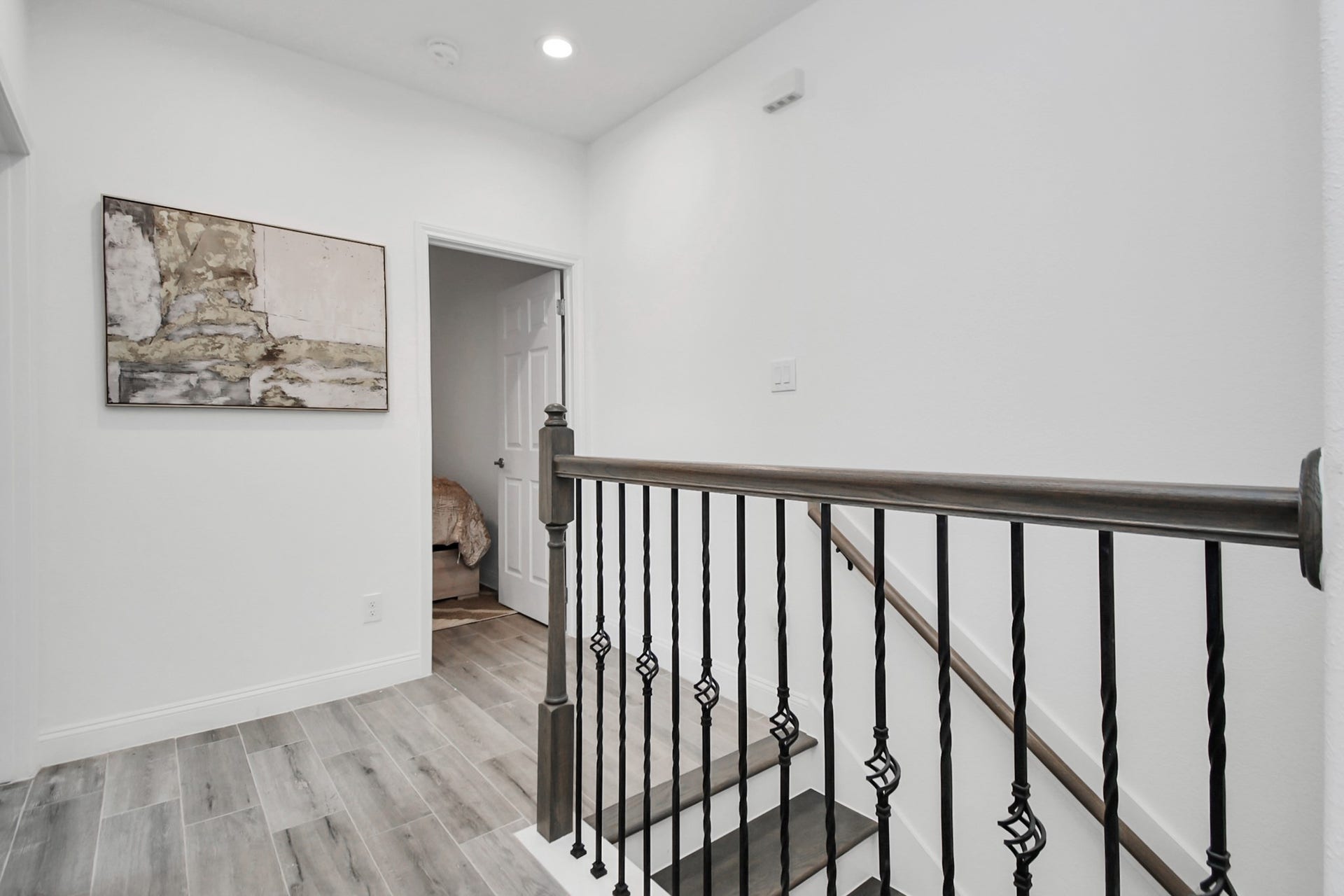 7812 Jester Street, Houston, TX 77051 The upper landing continues the home's sophisticated theme with stylish flooring, refined stair rails, and a bright, airy transition connecting the second-floor rooms.