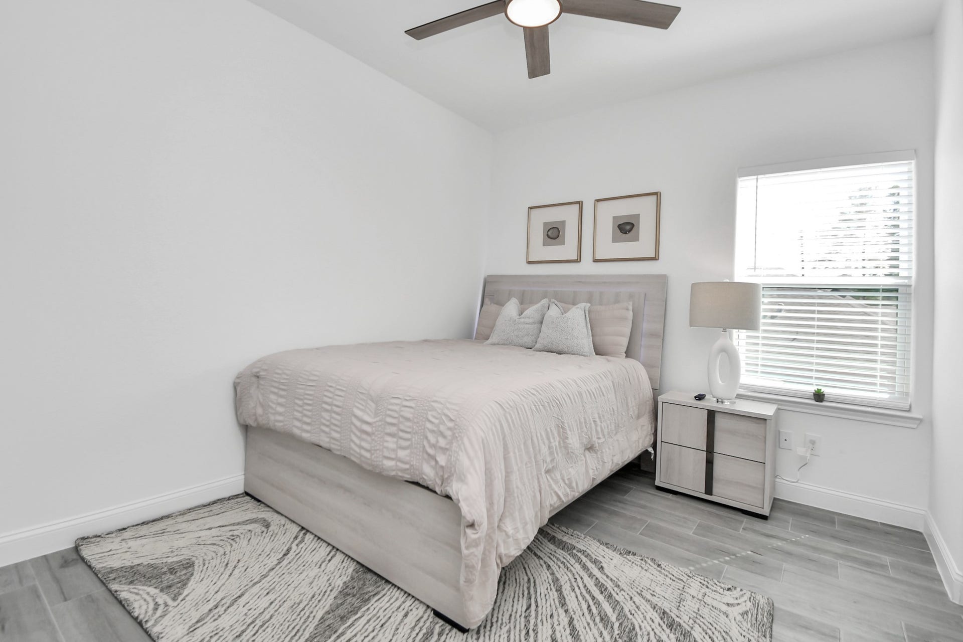 7812 Jester Street, Houston, TX 77051 Natural light streams through the bright window of this inviting bedroom, where a ceiling fan and crisp white palette create a clean, refreshing backdrop for personal style.