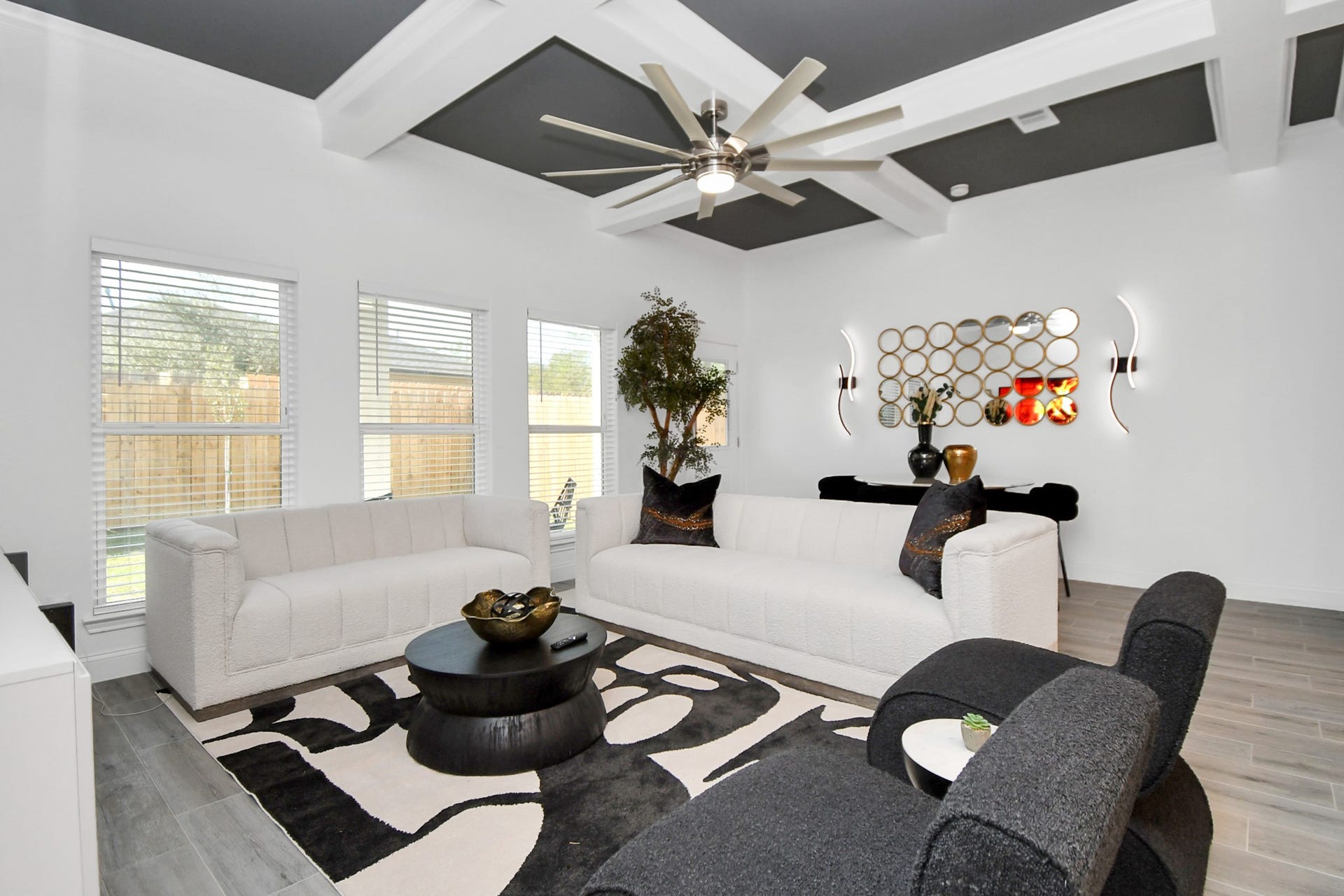 7812 Jester Street, Houston, TX 77051 A row of tall windows fills the living area with natural light while offering backyard views, creating a spacious setting that feels equally suited to quiet evenings or lively gatherings.