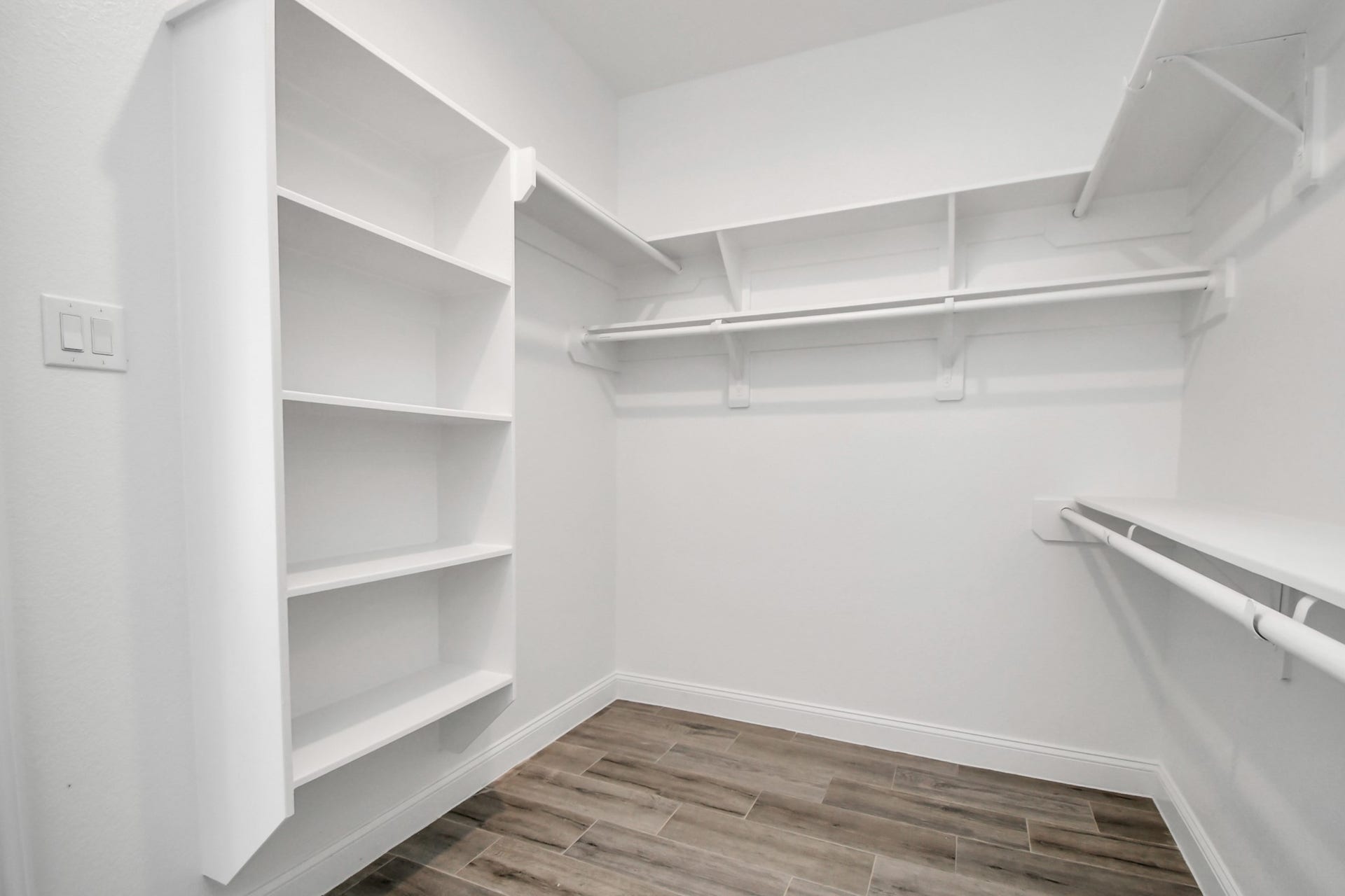 7812 Jester Street, Houston, TX 77051 Custom built-in shelving and hanging racks maximize floor-to-ceiling storage inside the primary closet space.