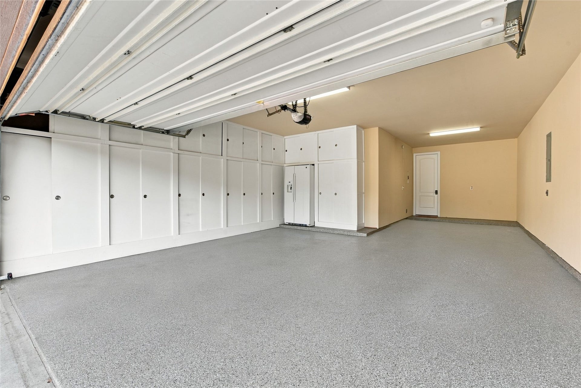 7343 Meadowcroft Boulevard, Sugar Land, TX 77479 Within the spacious three-car garage, there is ample built-in storage cabinets, a sleek epoxy floor and an outdoor refrigerator, perfect for organization and functionality.