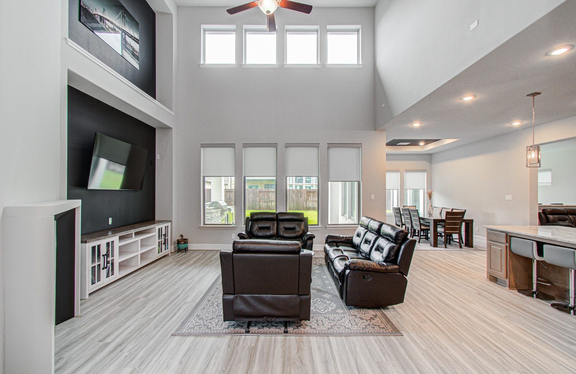 10015 Crescent Wood Drive, Missouri City, TX 77459 Living room with soaring ceilings and abundant windows for natural light.
