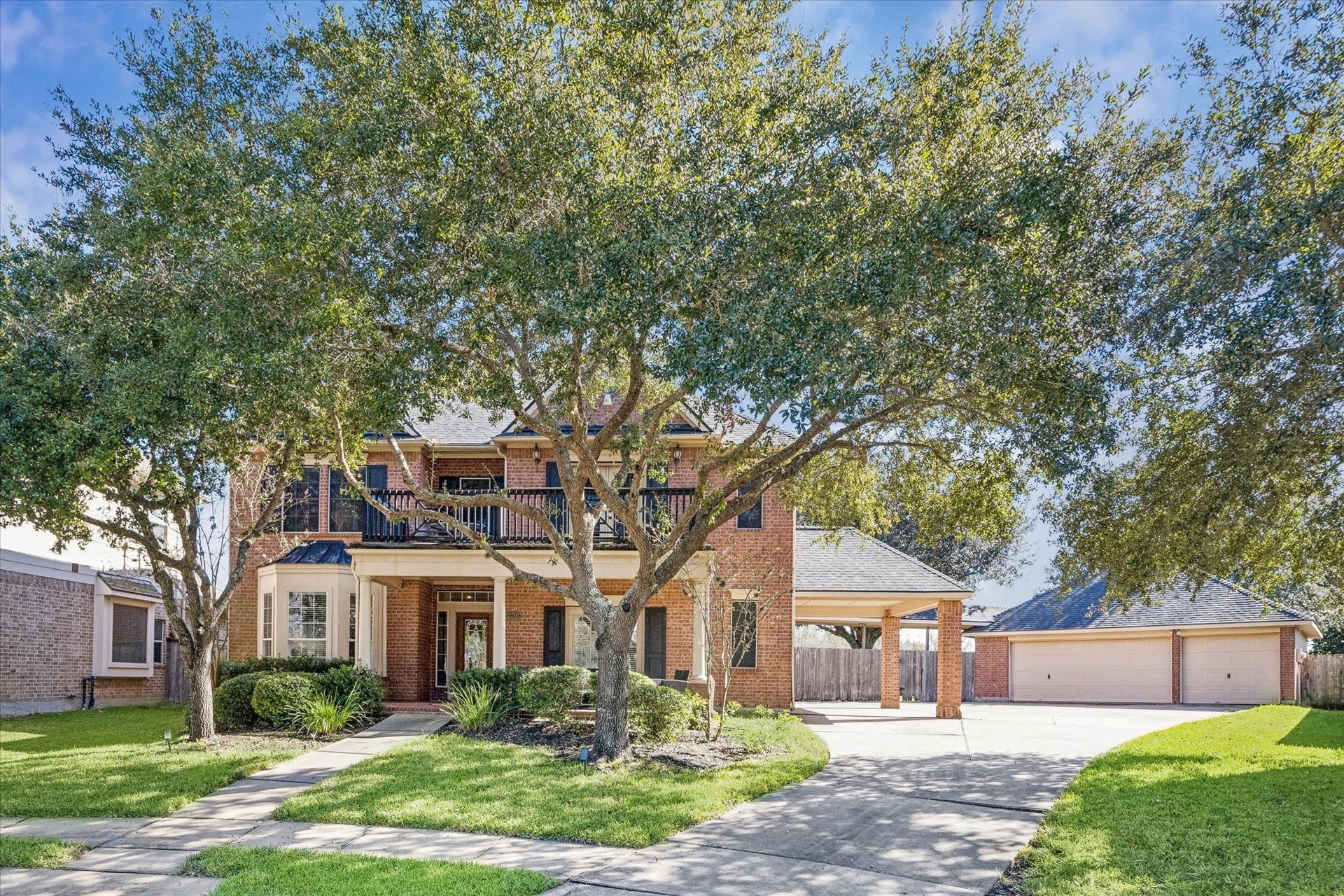 CLASSIC BRICK ELEVATION WITH MATURE TREES, COVERED FRONT PORCH, AND A GRAND PRESENCE ON A QUIET CUL-DE-SAC STREET.