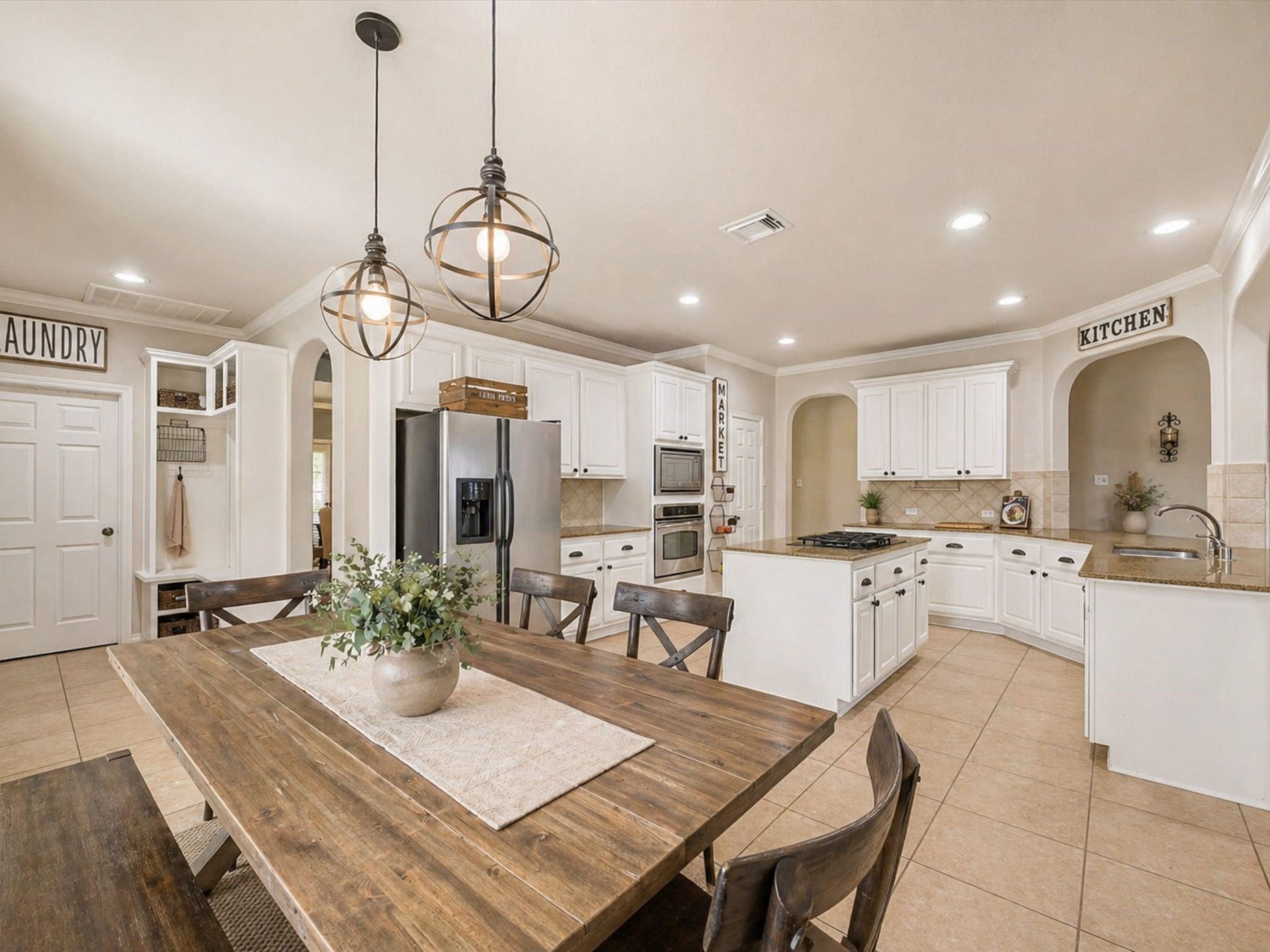 SPACIOUS KITCHEN WITH LARGE ISLAND, AMPLE CABINETRY, AND OPEN CONNECTION TO DINING AREA. **Virtually Staged.