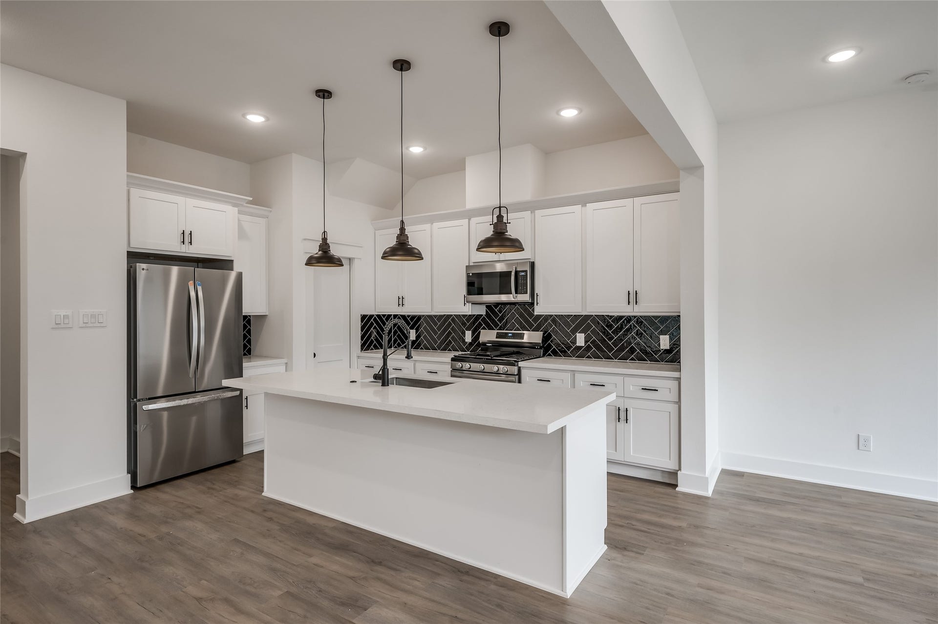 Another look at the kitchen, where sleek cabinetry and a stainless range make everyday cooking feel effortless