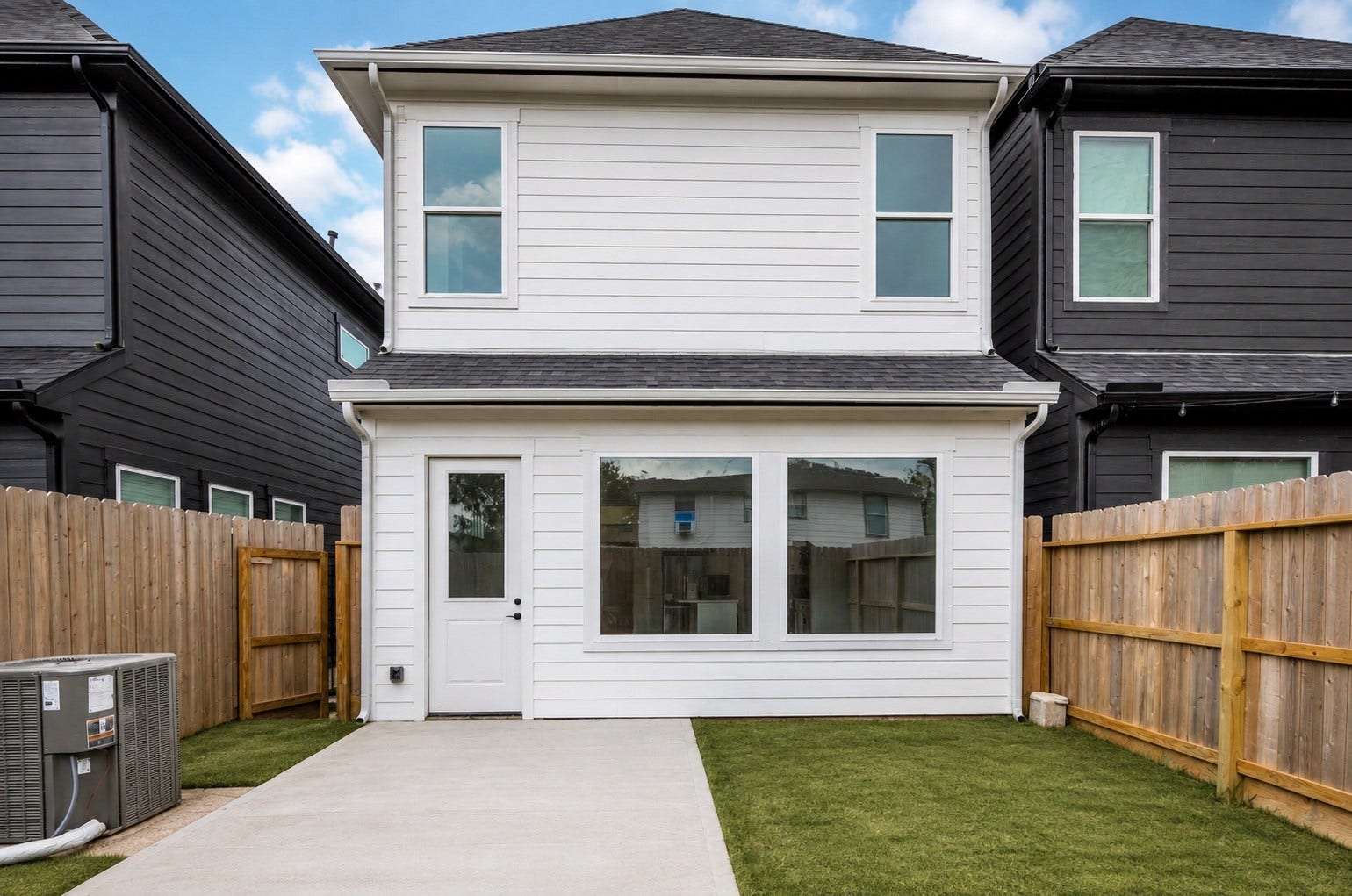 Out back, a covered patio area overlooks the yard, an easy spot to enjoy the outdoors