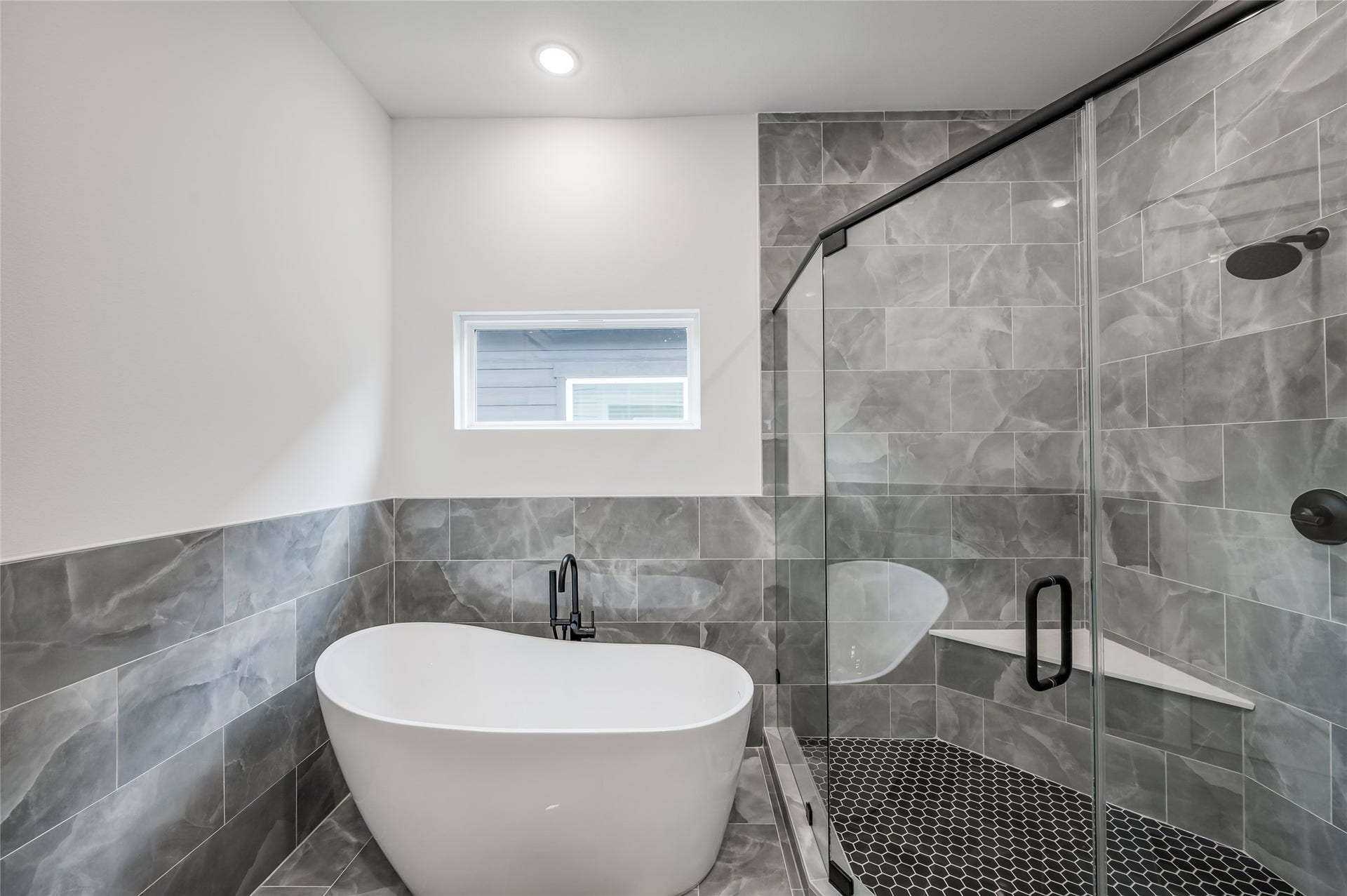 A soaking tub and separate shower give the primary bath a true retreat like feel