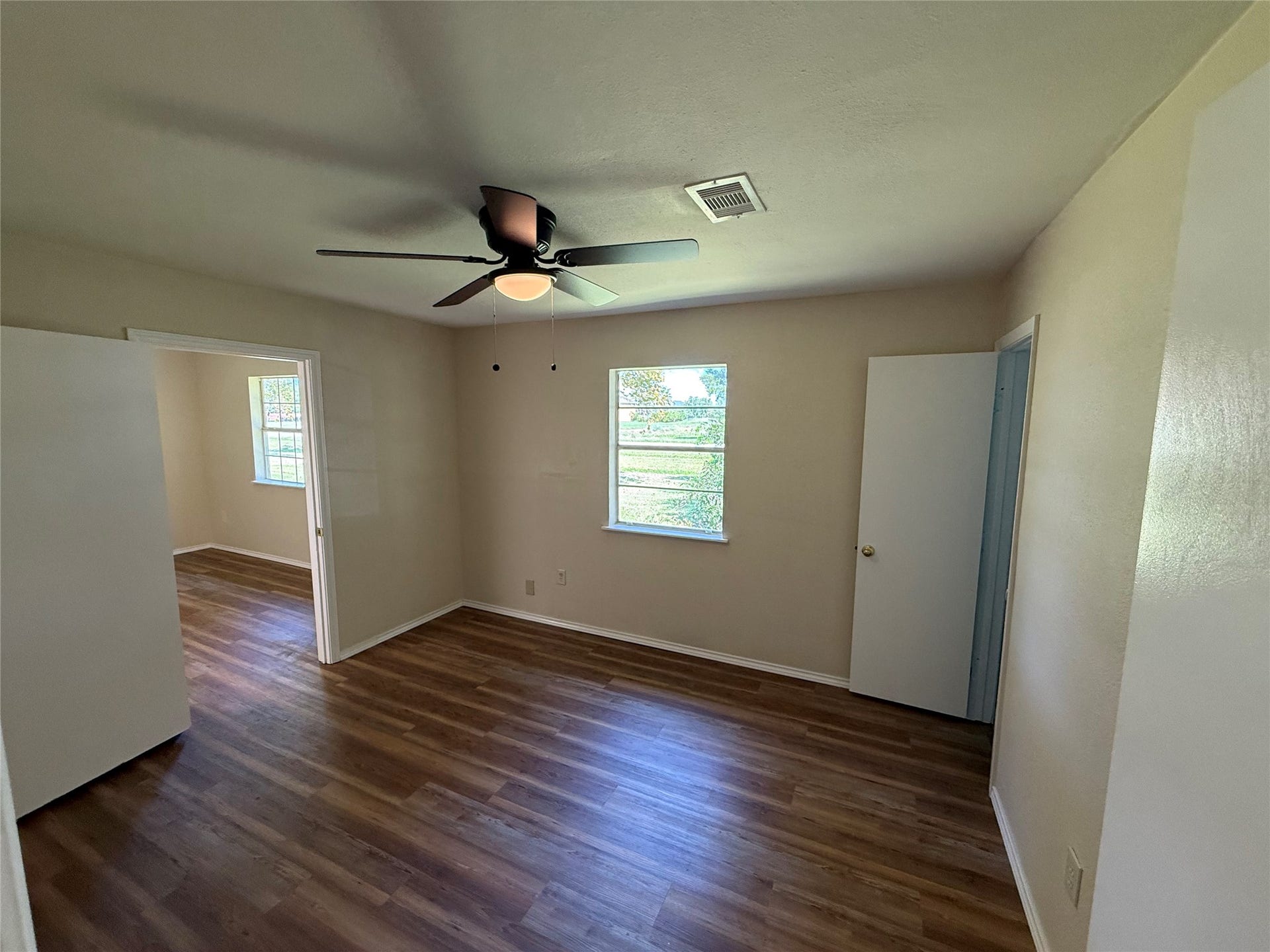 2524 Shouse Road, Santa Fe, TX 77510 Alternate view of the living area showing wood-look flooring and access to adjoining rooms.