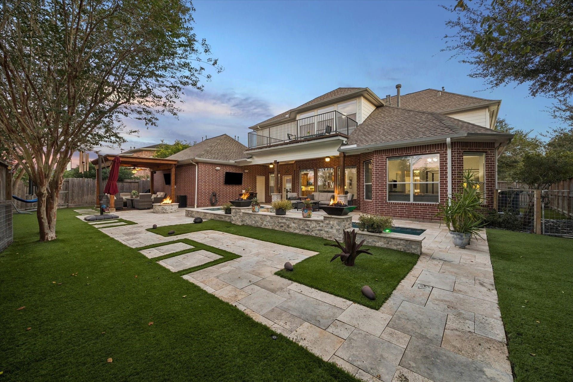 3523 Silvercreek Drive, Manvel, TX 77578 Professionally created backyard features turf grass with sprinkler system, limestone surround, built-in speakers, 2 televisions, pool firepits and gathering firepit to create entertaining at its best