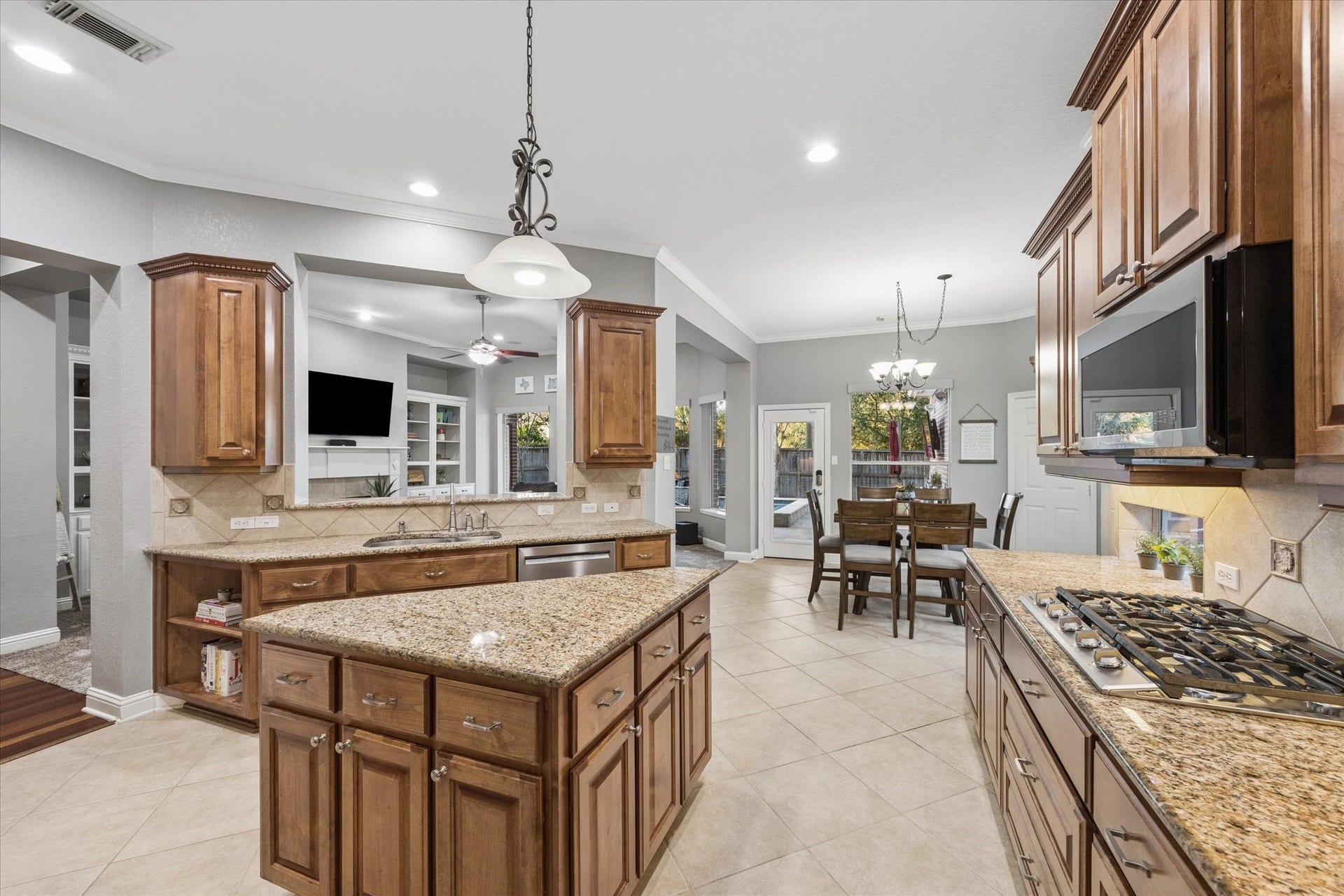 3523 Silvercreek Drive, Manvel, TX 77578 Kitchen opens to living and breakfast room with views and access to the beautiful backyard