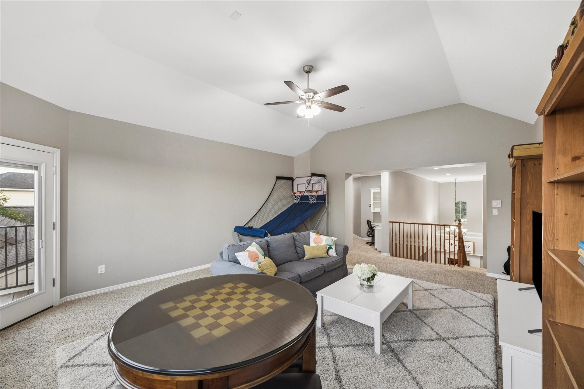 3523 Silvercreek Drive, Manvel, TX 77578 Game room looking towards built-in desk area and staircase
