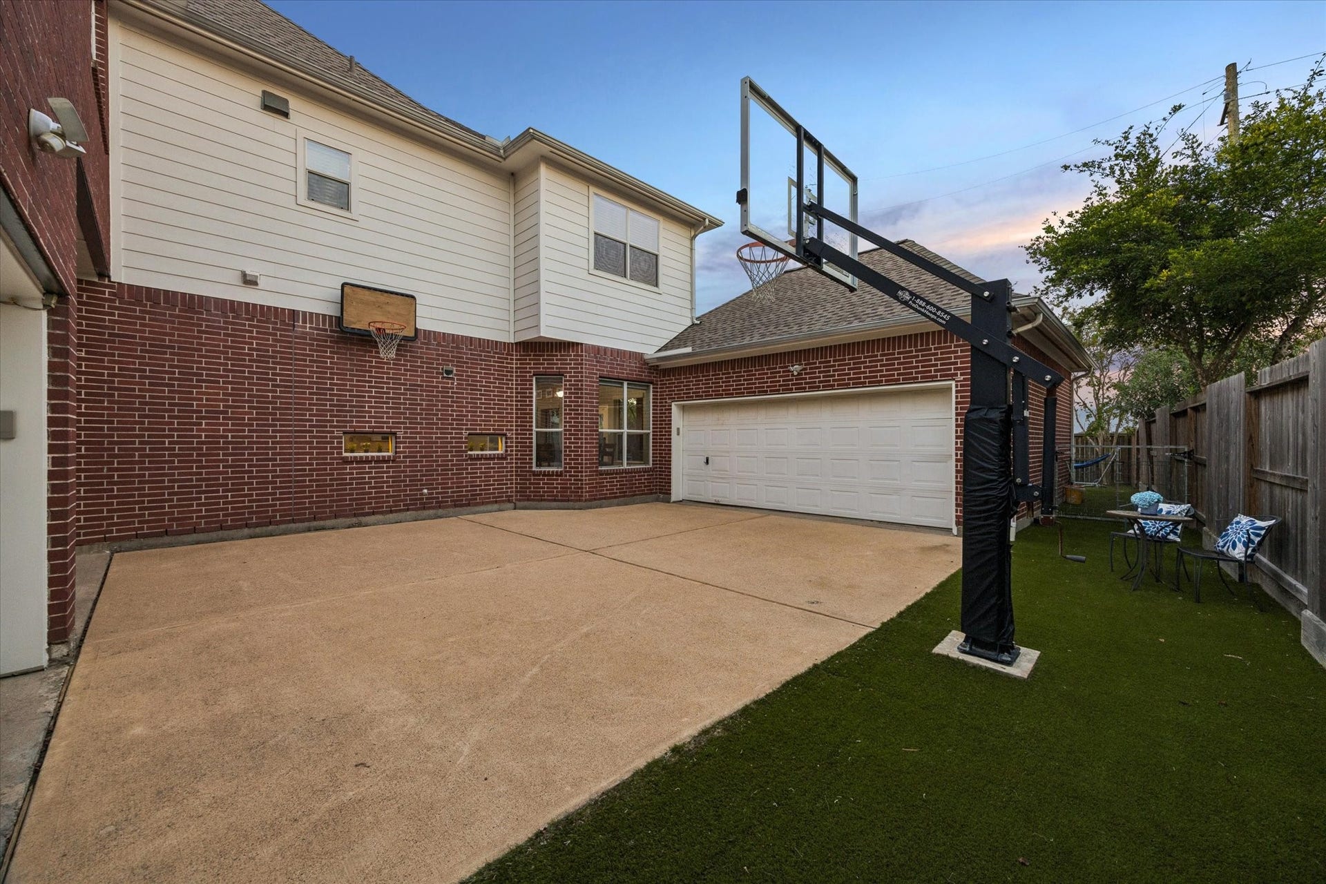 3523 Silvercreek Drive, Manvel, TX 77578 Motor court to the 2 garages with turf grass and room for basketball and play area