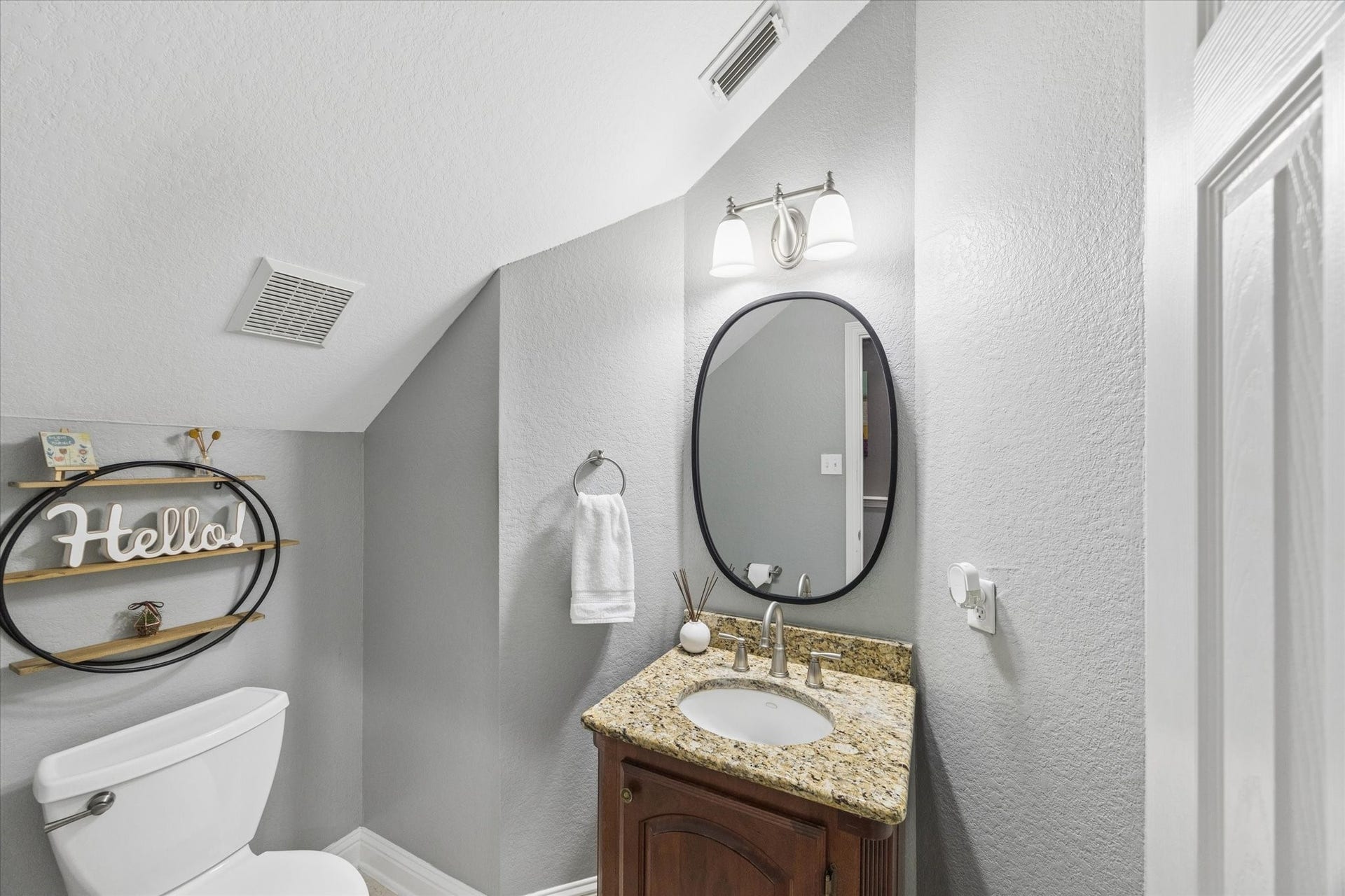 3523 Silvercreek Drive, Manvel, TX 77578 Powder room with granite vanity and oval accent mirror