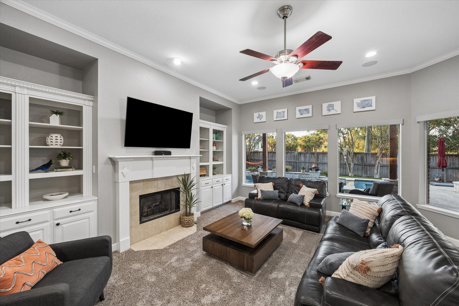 3523 Silvercreek Drive, Manvel, TX 77578 Living room with picture windows offering views towards backyard and pool area