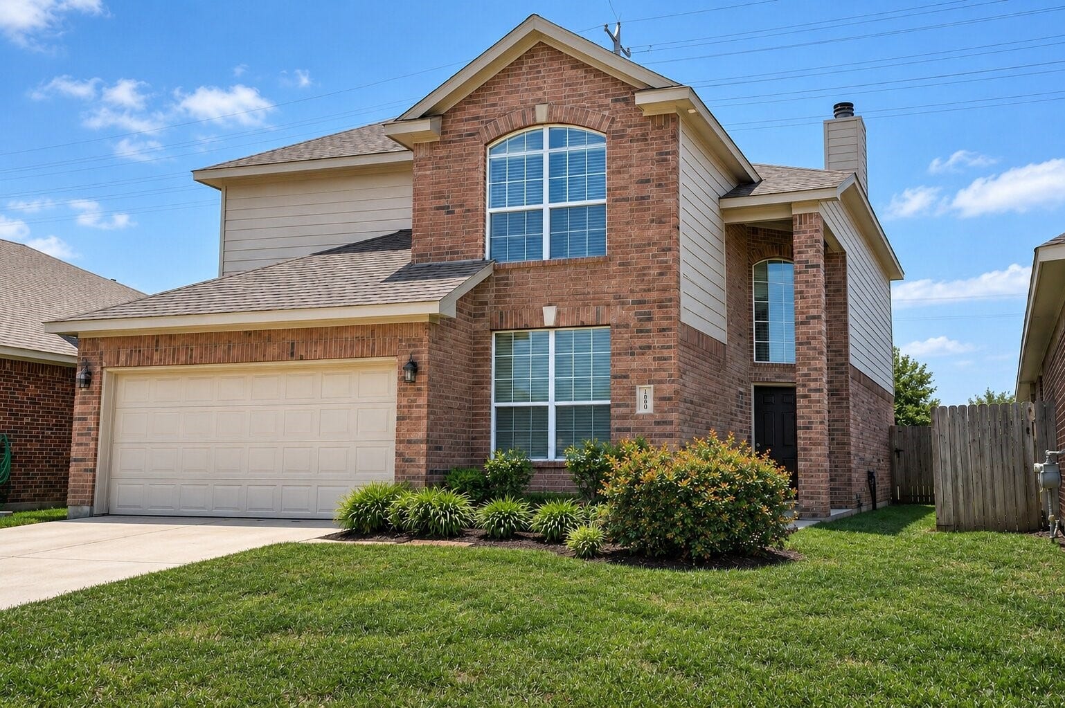 26339 Richwood Oaks Drive, Katy, TX 77494 Charming two-story brick home with a spacious two-car garage, large windows for natural light, and a well-maintained lawn, perfect for family living.