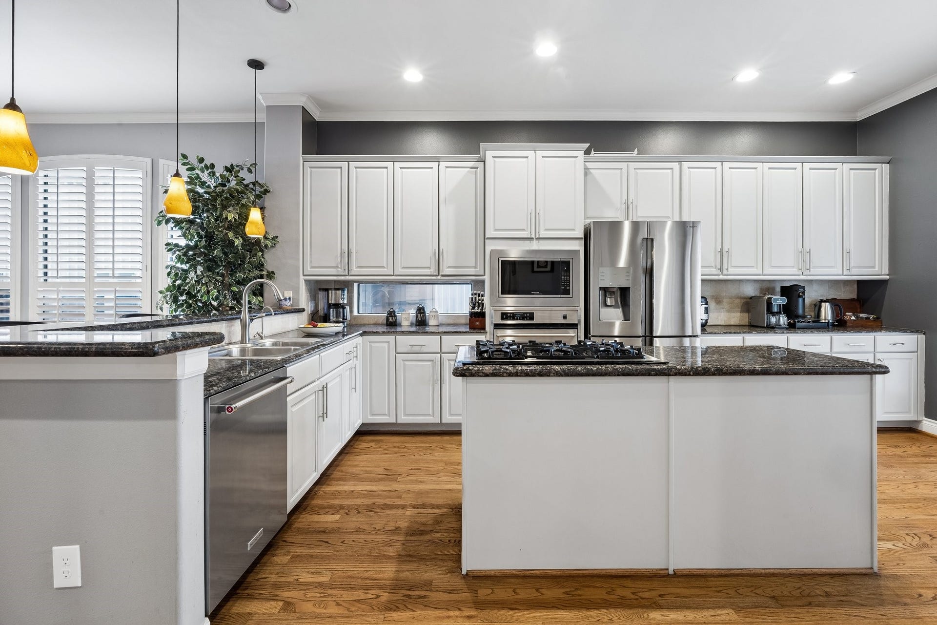The kitchen is a chef's delight with lovely cabinets, stainless steel appliances, island cook top and breakfast area that leads to the large other balcony that us perfect for grilling and outdoor eating