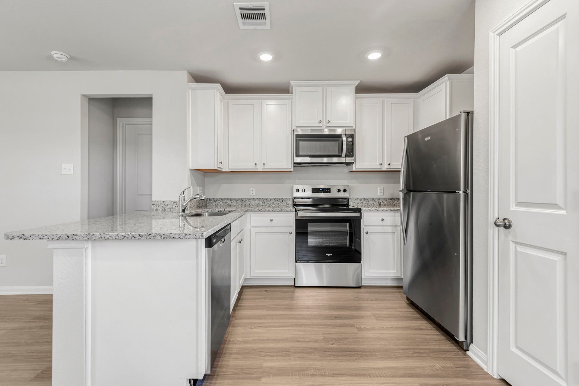 6423 Autumn Equinox Drive, Houston, TX 77048 The kitchen is upgraded with Whirlpool appliances and granite countertops.
