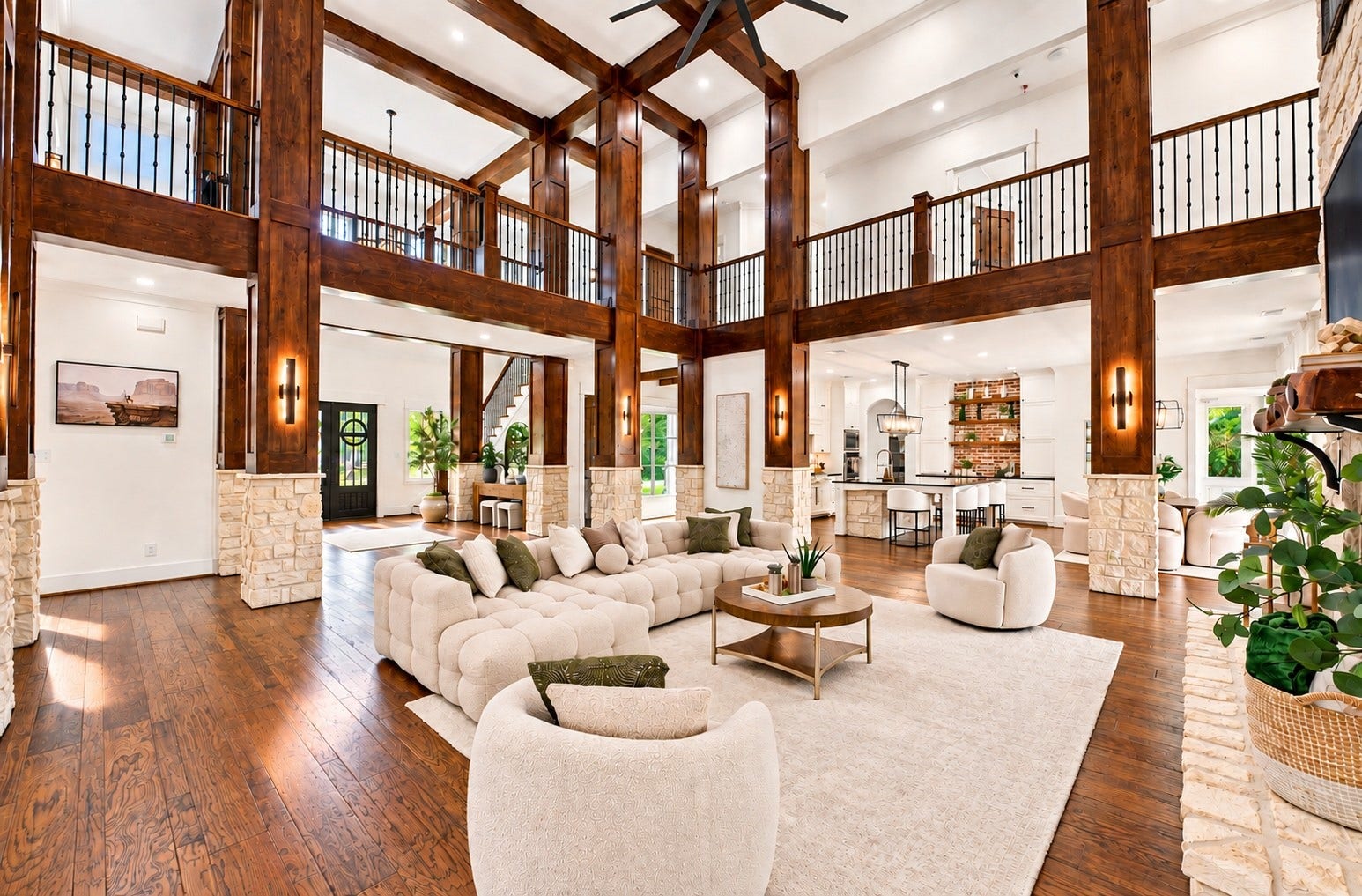 37753 Marias Way, Magnolia, TX 77354 The dramatic two-story family room features soaring ceilings, exposed wood beams, expansive windows and a floor-to-ceiling stone fireplace, creating an impressive centerpiece for the home.