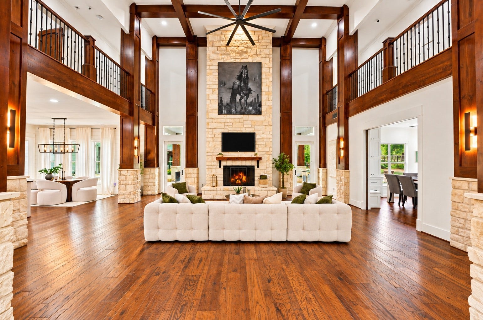 37753 Marias Way, Magnolia, TX 77354 At the heart of the two-story family room, a dramatic floor-to-ceiling stone fireplace is framed by rich wood beams and walls of windows overlooking the property.