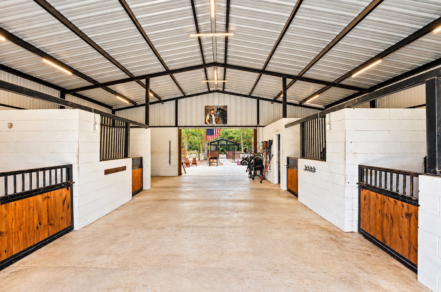 37753 Marias Way, Magnolia, TX 77354 The barn is thoughtfully configured with multiple stalls and a wide center aisle, providing a dedicated setup for horses and other animals.