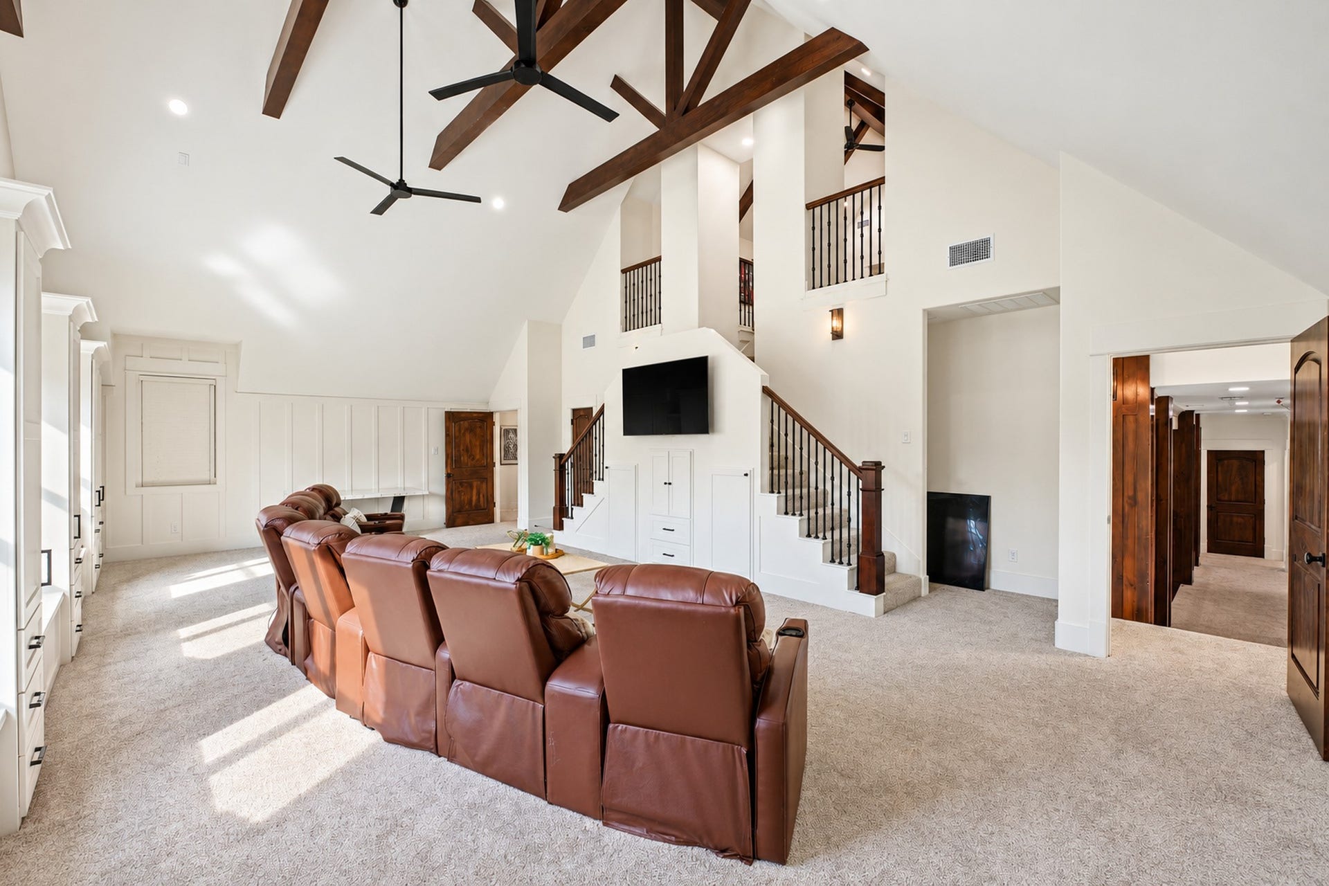 37753 Marias Way, Magnolia, TX 77354 A dedicated staircase connects the second-floor game room to the additional third-level recreation and media spaces.
