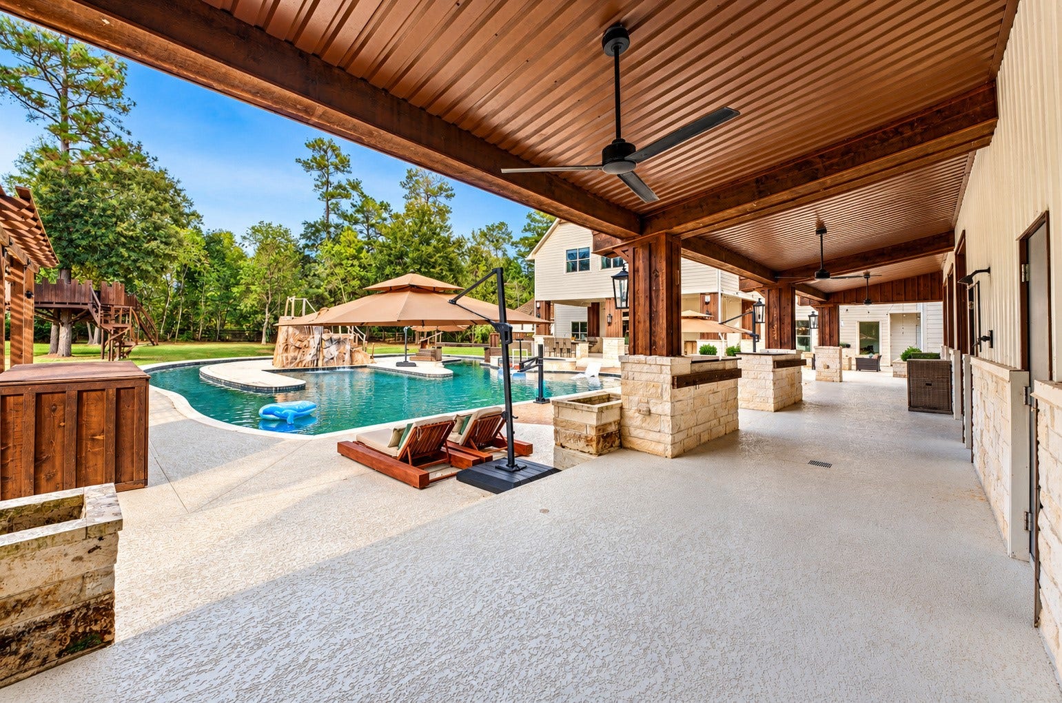 37753 Marias Way, Magnolia, TX 77354 An additional covered entertaining area extends along the metal building and overlooks the pool, providing even more shaded space for gathering, dining and relaxing.