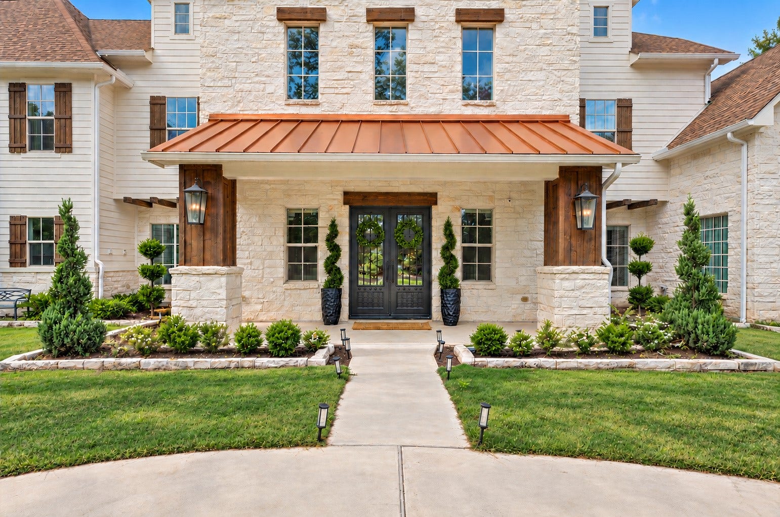 37753 Marias Way, Magnolia, TX 77354 A closer look at the welcoming front entry, where stone, warm wood accents and a copper-toned roof create a distinctive arrival.