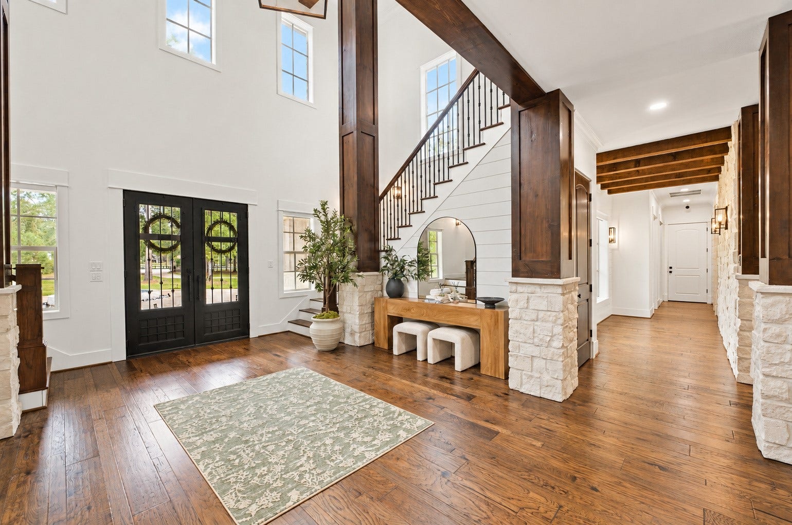 37753 Marias Way, Magnolia, TX 77354 Another view of the impressive entry showcases the soaring ceiling, warm hardwood floors, rich wood accents and open connection to the surrounding living spaces.