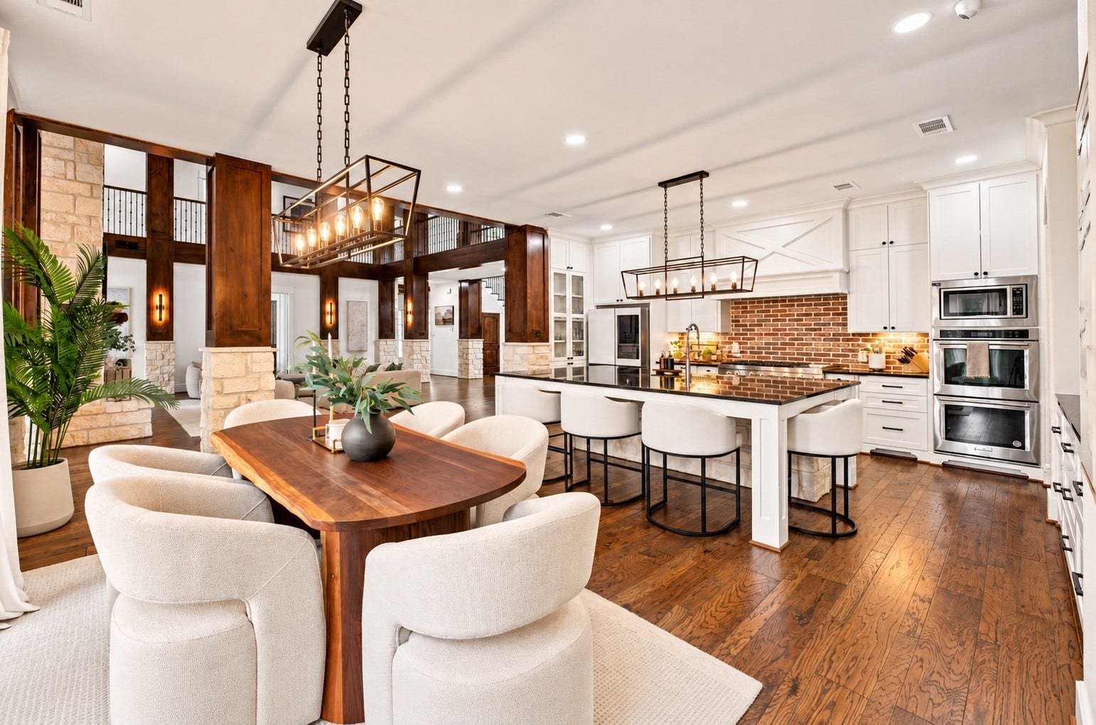 37753 Marias Way, Magnolia, TX 77354 The open-concept kitchen and breakfast area connect seamlessly with the family room, creating an expansive gathering space filled with natural light.