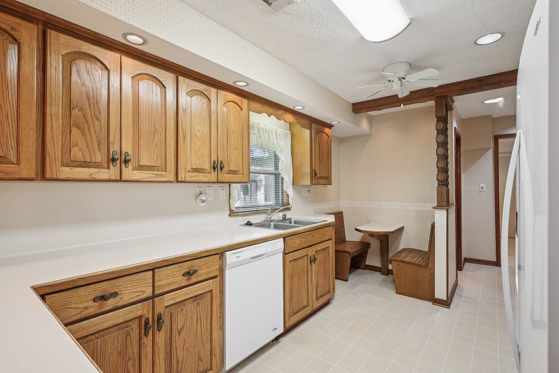 4733 Oleander Street, Bacliff, TX 77518 The kitchen features solid wood cabinets and a great built in seating area for two...