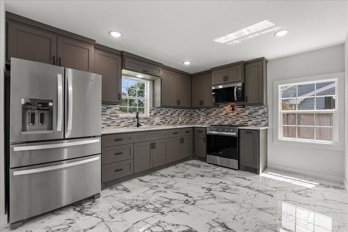 1105 W Ellaine Avenue, Pasadena, TX 77506 Fully remodeled kitchen with stainless steel appliances and ample cabinetry.