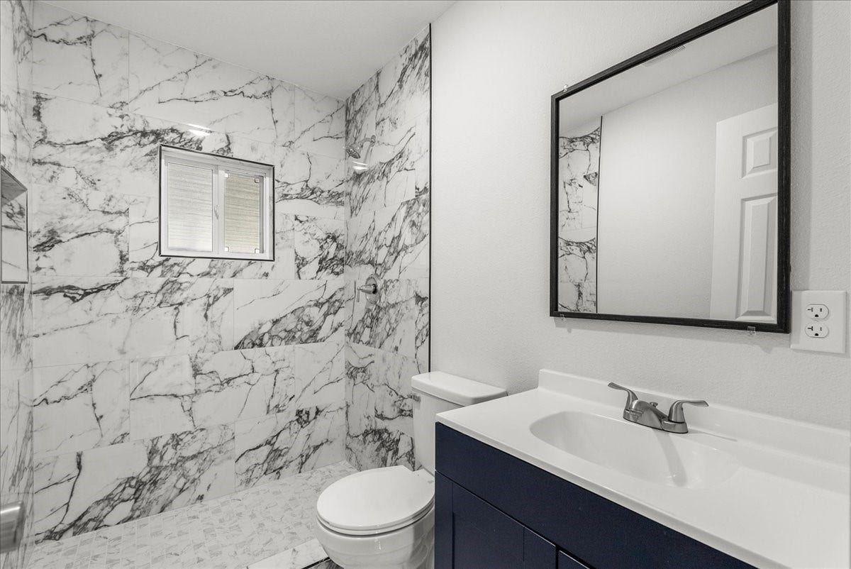 1105 W Ellaine Avenue, Pasadena, TX 77506 Stylish full bathroom with contemporary finishes and designer tile surround.
