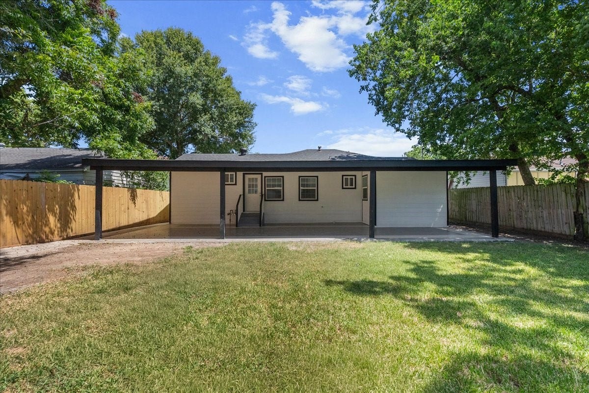 1105 W Ellaine Avenue, Pasadena, TX 77506 Rear exterior showcasing the covered patio and spacious fenced yard.