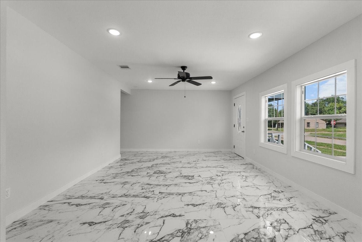 1105 W Ellaine Avenue, Pasadena, TX 77506 Spacious living area with oversized windows and designer flooring.