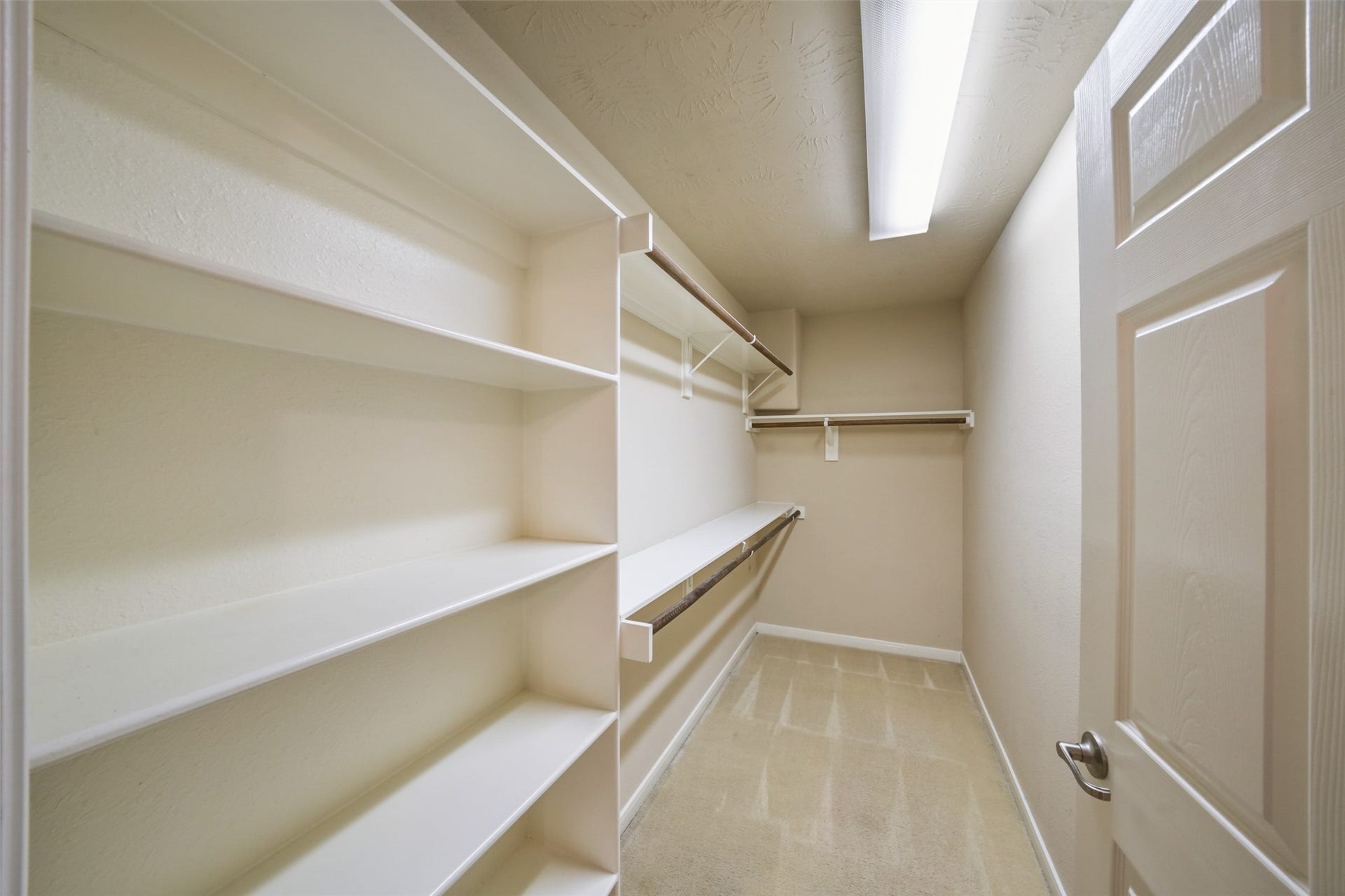 7 Fitzroy Place, Conroe, TX 77384 Spacious primary closet with built in shelves and plenty of hanging space.