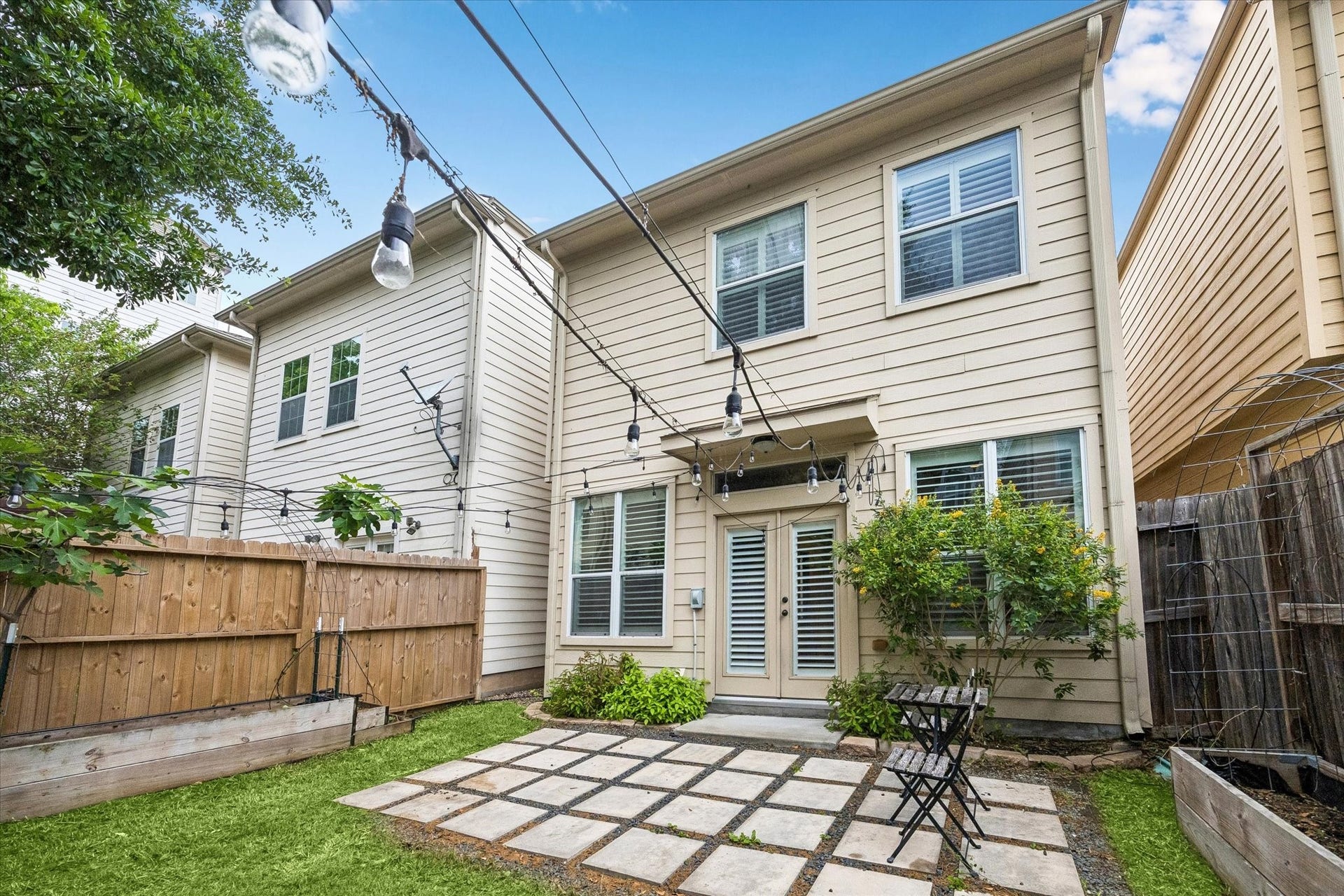 5513 Petty Street, #C, Houston, TX 77007 Rear exterior view showcasing fenced yard and inviting outdoor retreat.