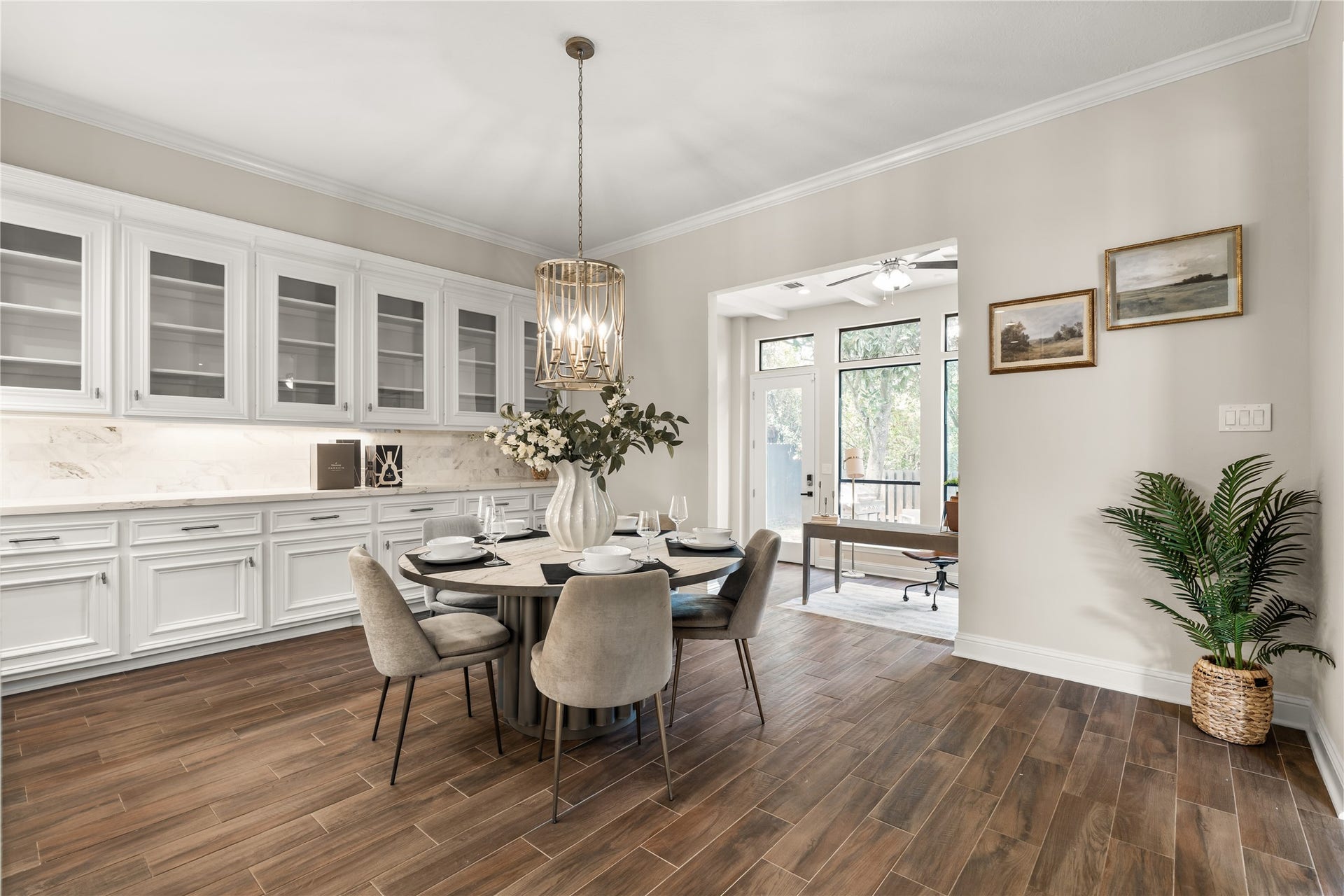 4719 Breezy Point Drive, Houston, TX 77345 Elegant cabinetry, statement lighting, and warm flooring create an inviting breakfast room with an effortless connection to the kitchen.