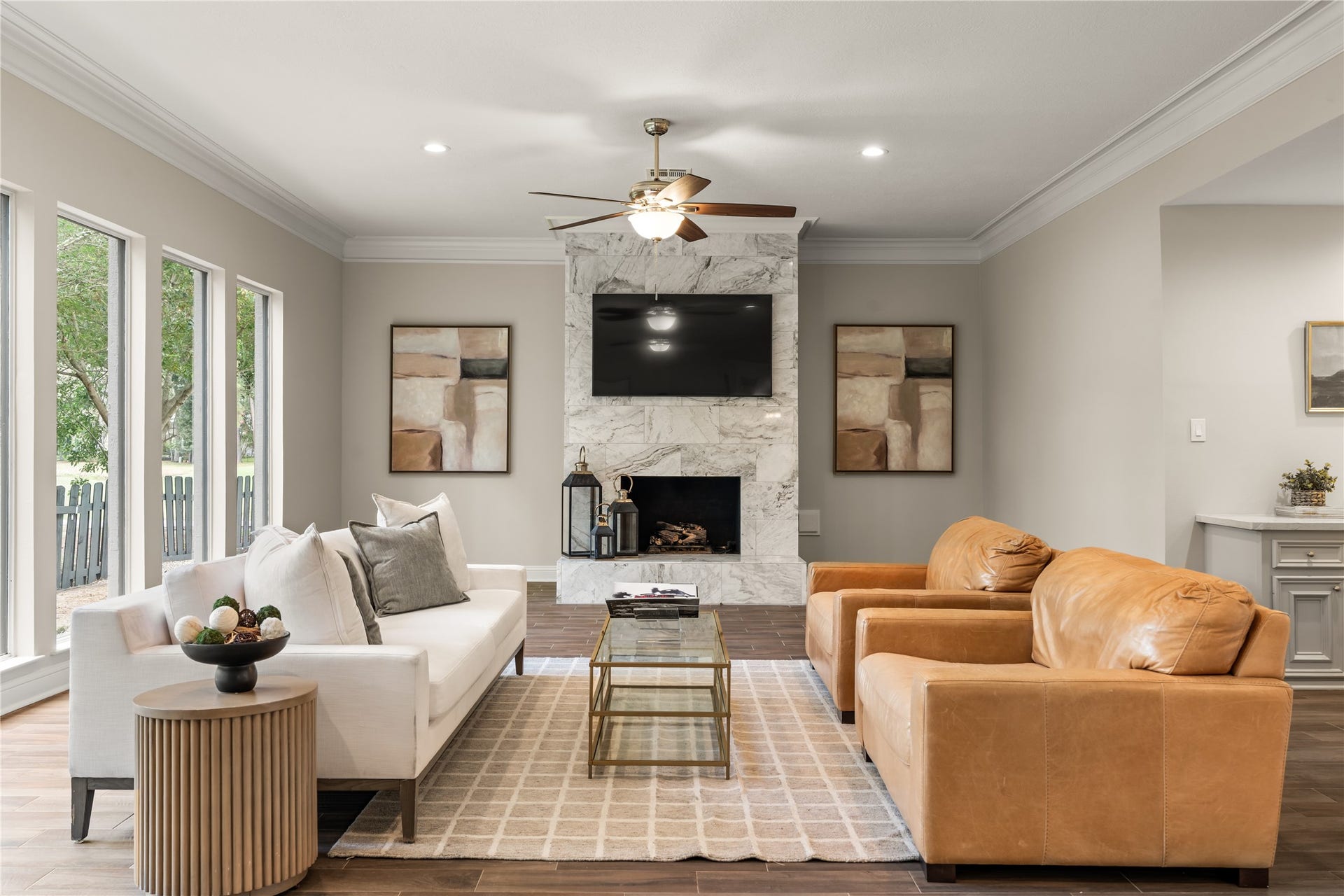 4719 Breezy Point Drive, Houston, TX 77345 Designed for gracious everyday living and entertaining, this spacious gathering room pairs a statement fireplace with abundant natural light and warm finishes.