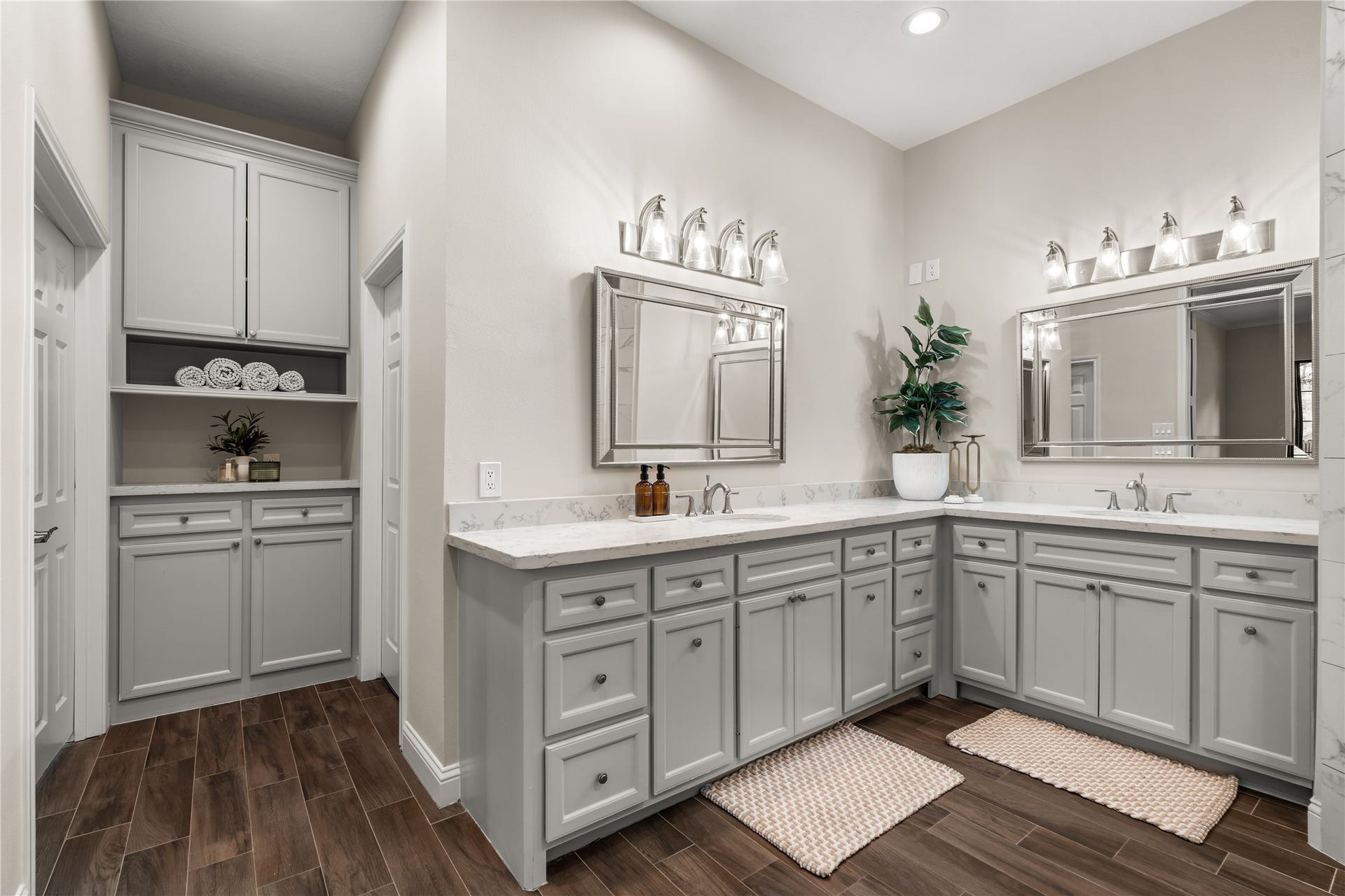 4719 Breezy Point Drive, Houston, TX 77345 Well appointed primary ensuite featuring dual vanities, generous counter space, abundant cabinetry, and a dedicated built-in storage area.