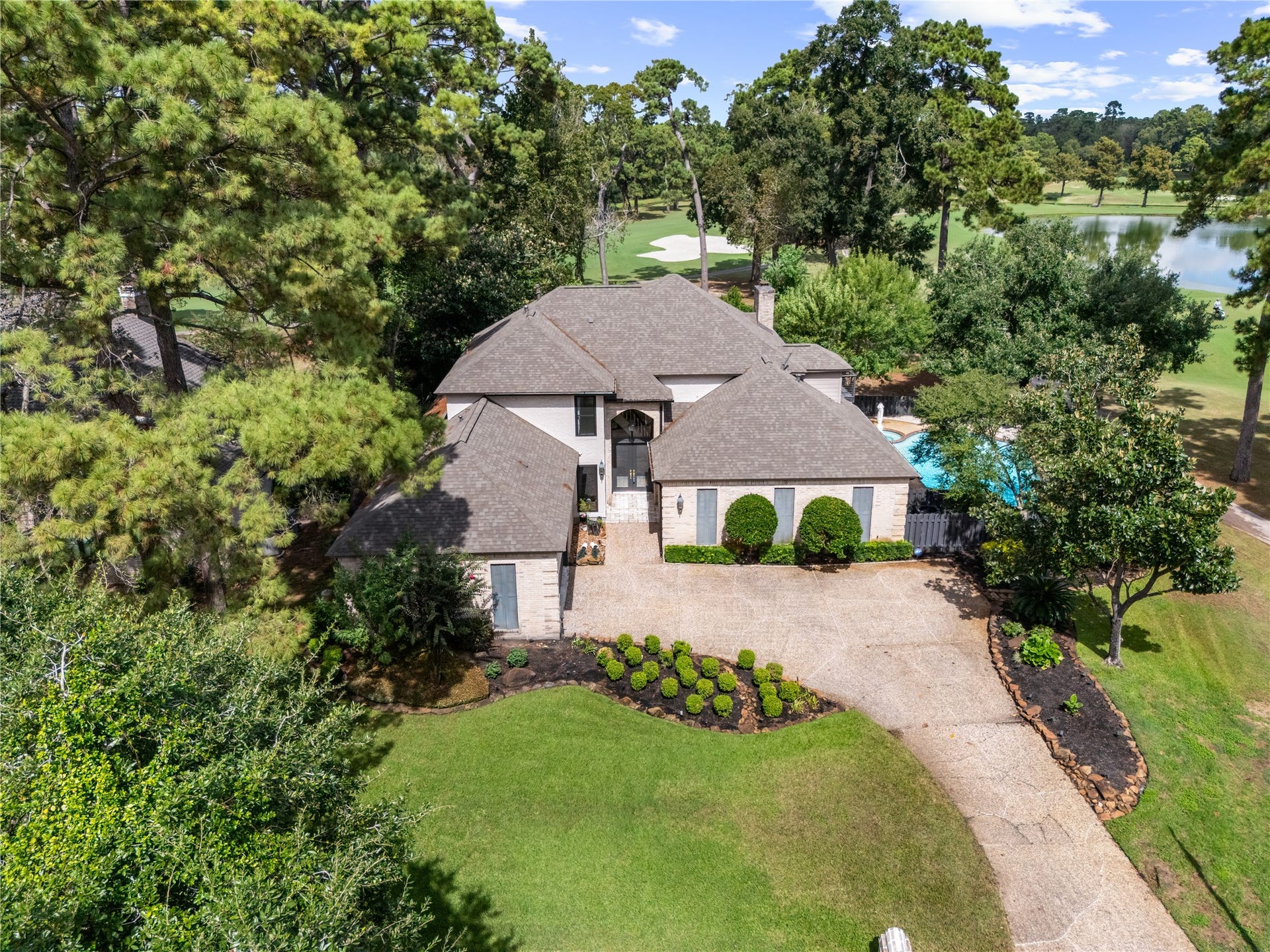 4719 Breezy Point Drive, Houston, TX 77345 An exceptional setting elevates this residence, ideally positioned along the golf course with tranquil water views and lush greenery creating a private, resort like backdrop.