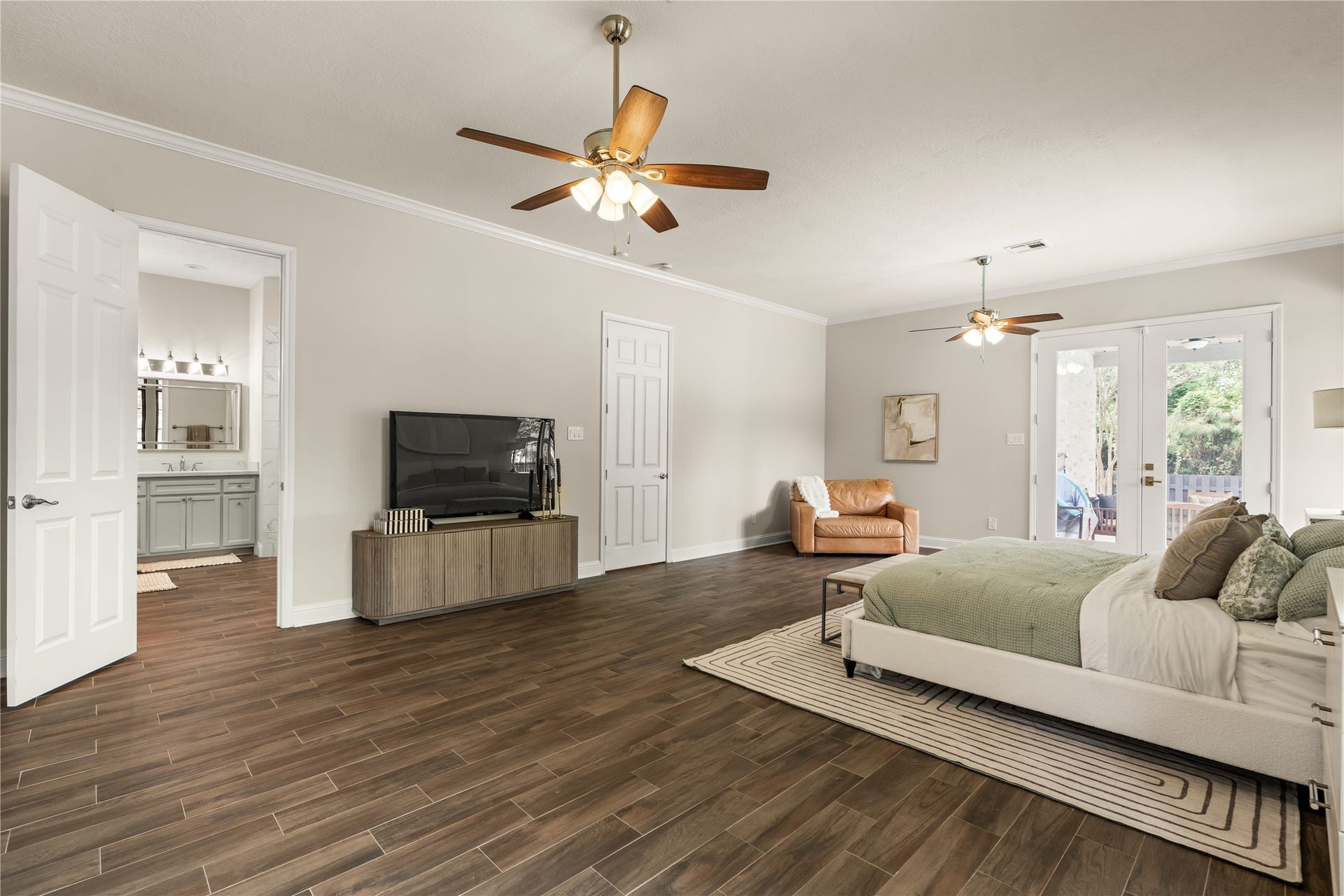 4719 Breezy Point Drive, Houston, TX 77345 Elegant primary suite offering impressive proportions, an inviting sense of comfort, and seamless connection to the private en-suite.