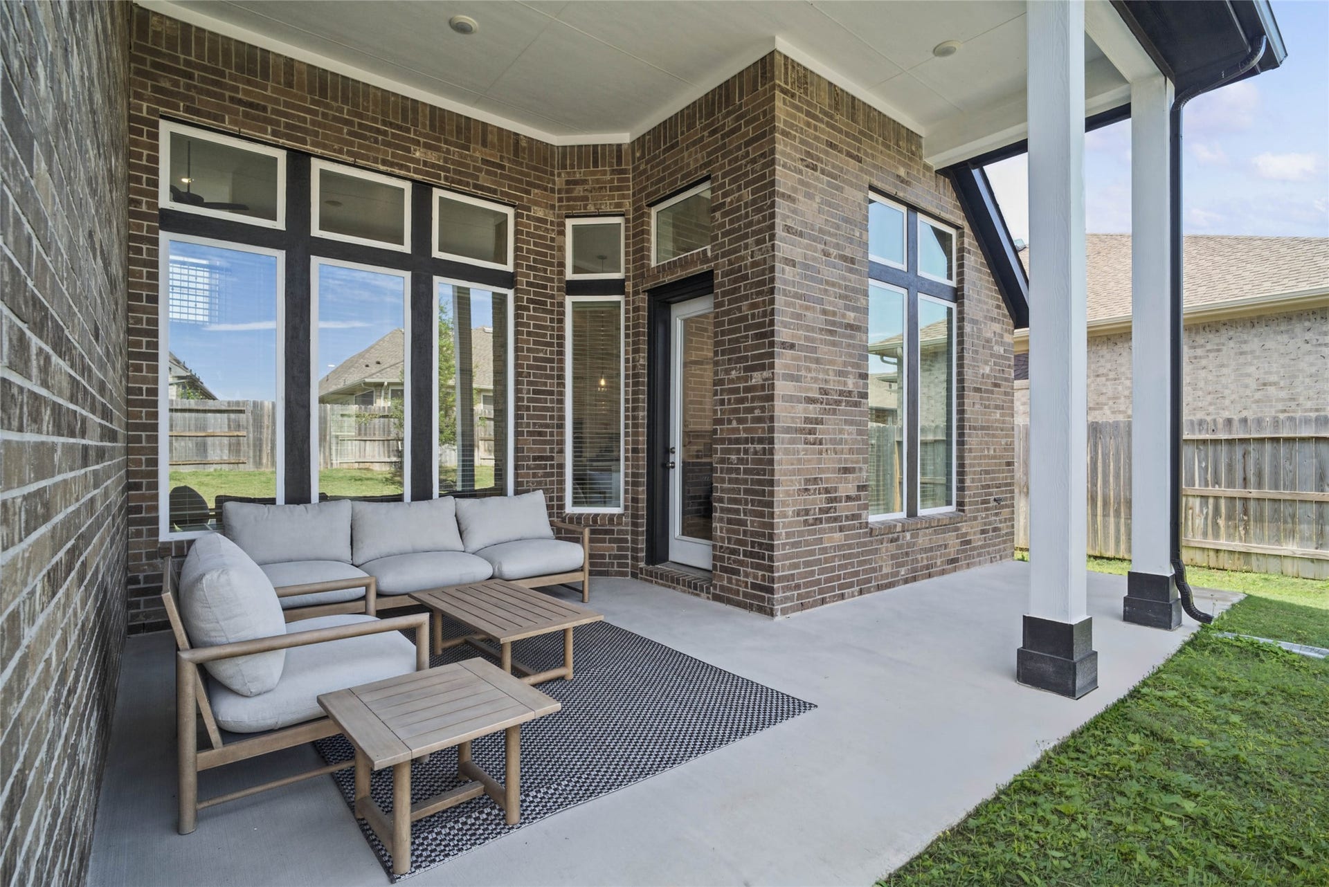 Step outside to the covered rear patio, the perfect extension of your indoor living space for year-round enjoyment.