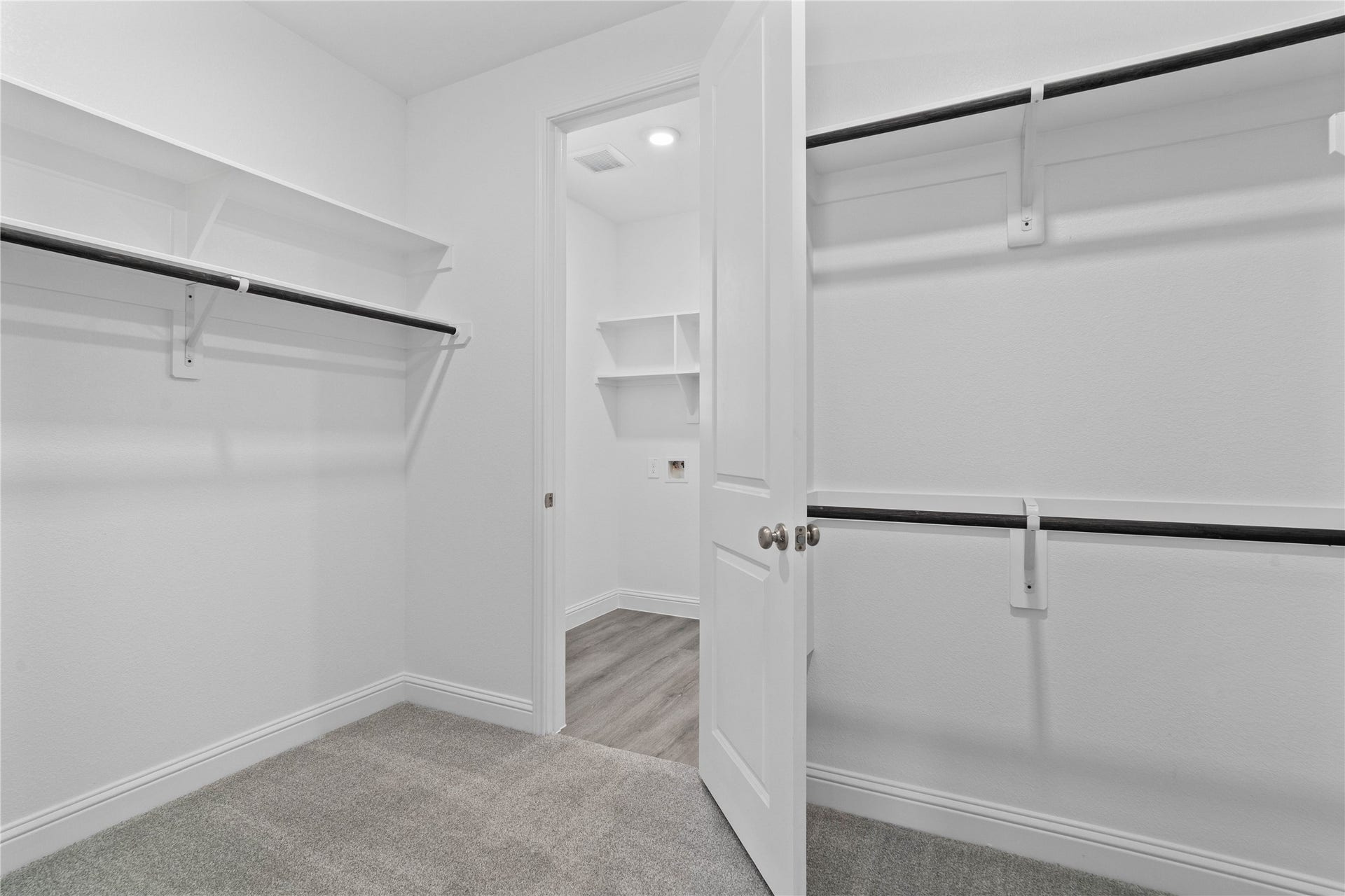 Look at this immaculate closet! With high shelving, multiple rows to hang clothing, you are sure to have enough room for all your belongings! Additional feature is the easy access into the laundry room from primary walk-in closet.