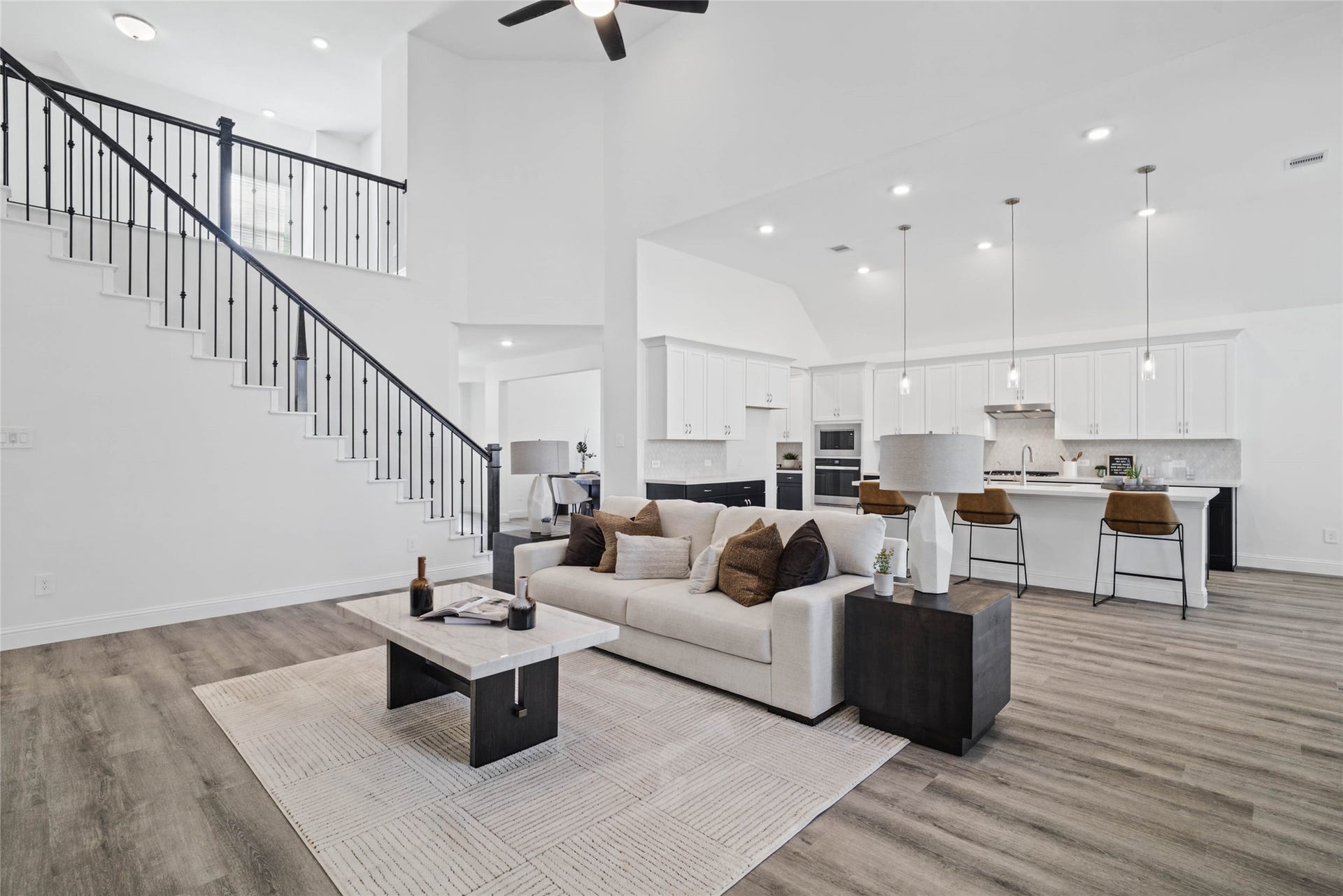 Open concept living space connecting the family, kitchen, breakfast nook and overlooking views of the second floor landing.