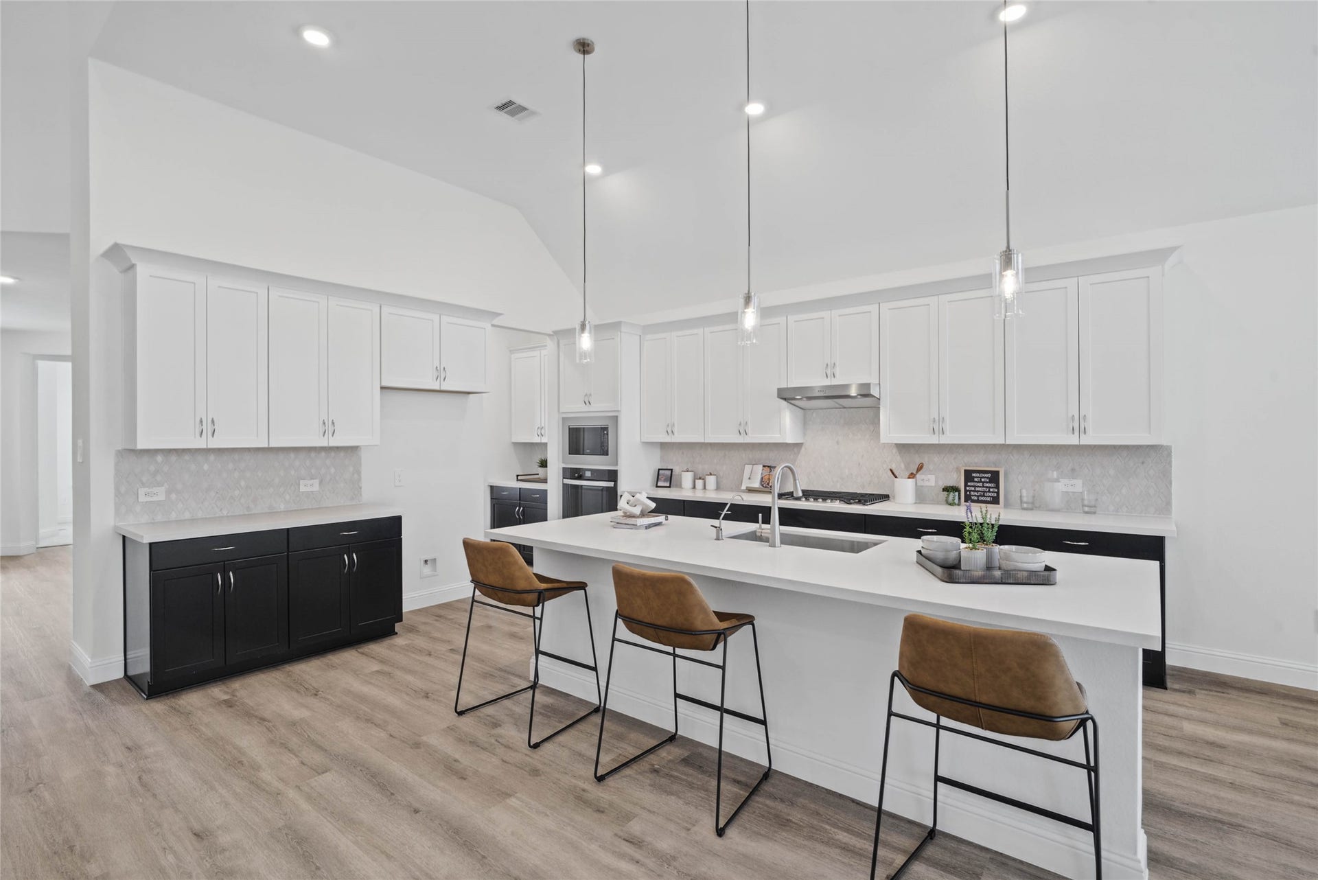 Pristine and functional, the central kitchen island provides both a focal point and practical prep space in this modern gourmet kitchen.