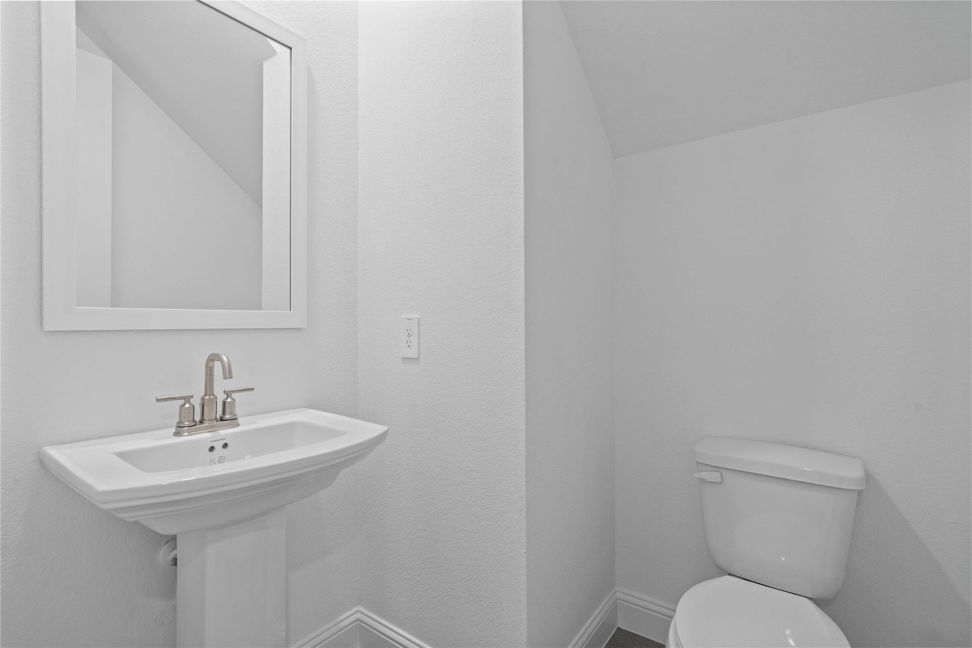 The powder bath features a stylish vanity and a clean, modern design.