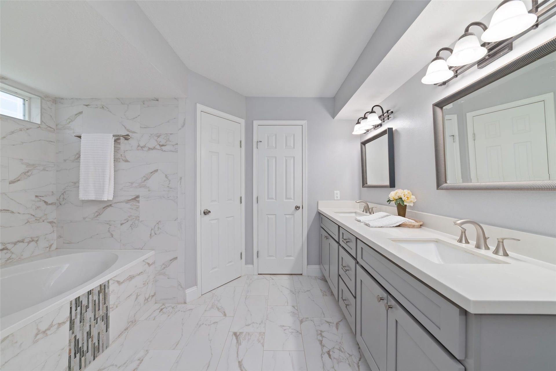13007 New Cypress Drive, Cypress, TX 77429 Room to relax, refresh, and recharge! Another view of the spacious Primary Bath showcases the expansive double-sink vanity, generous countertop space, and beautiful marble-look tile flooring. The custom-tiled tub/shower combination adds a touch of elegance, creating a comfortable retreat for everyday routines.