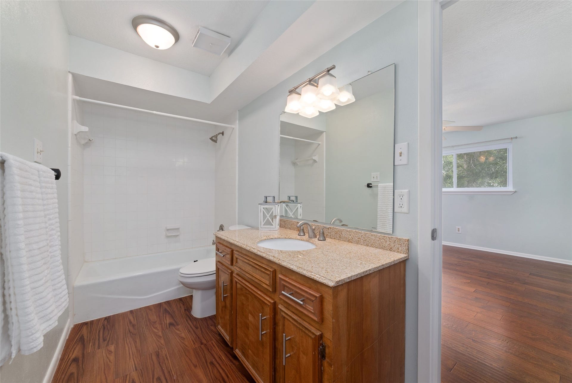 13007 New Cypress Drive, Cypress, TX 77429 Private en-suite bathroom serving the upstairs secondary bedroom features a spacious wood vanity with granite countertop, brushed nickel fixtures, and tub/shower combination.